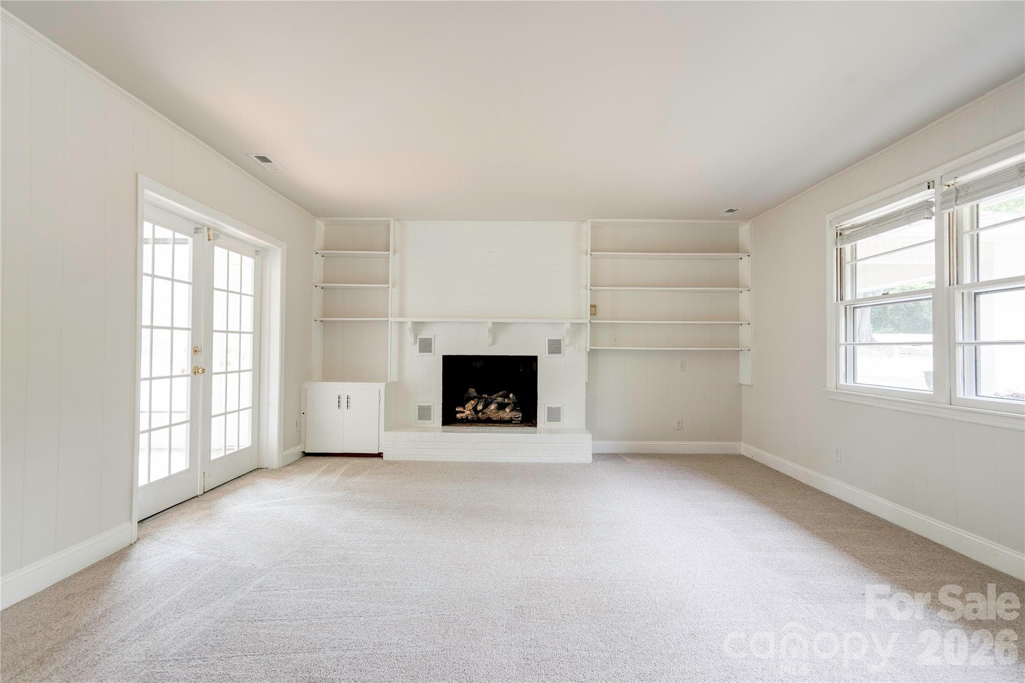 New carpet in den with gas log fireplace. - Shelby