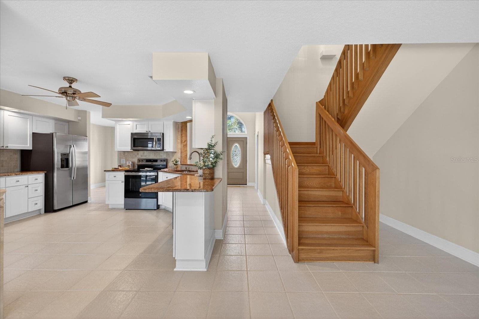 Standing in living room facing foyer and stairs - 3640 HARBORVIEW CT, NEW PORT RICHEY