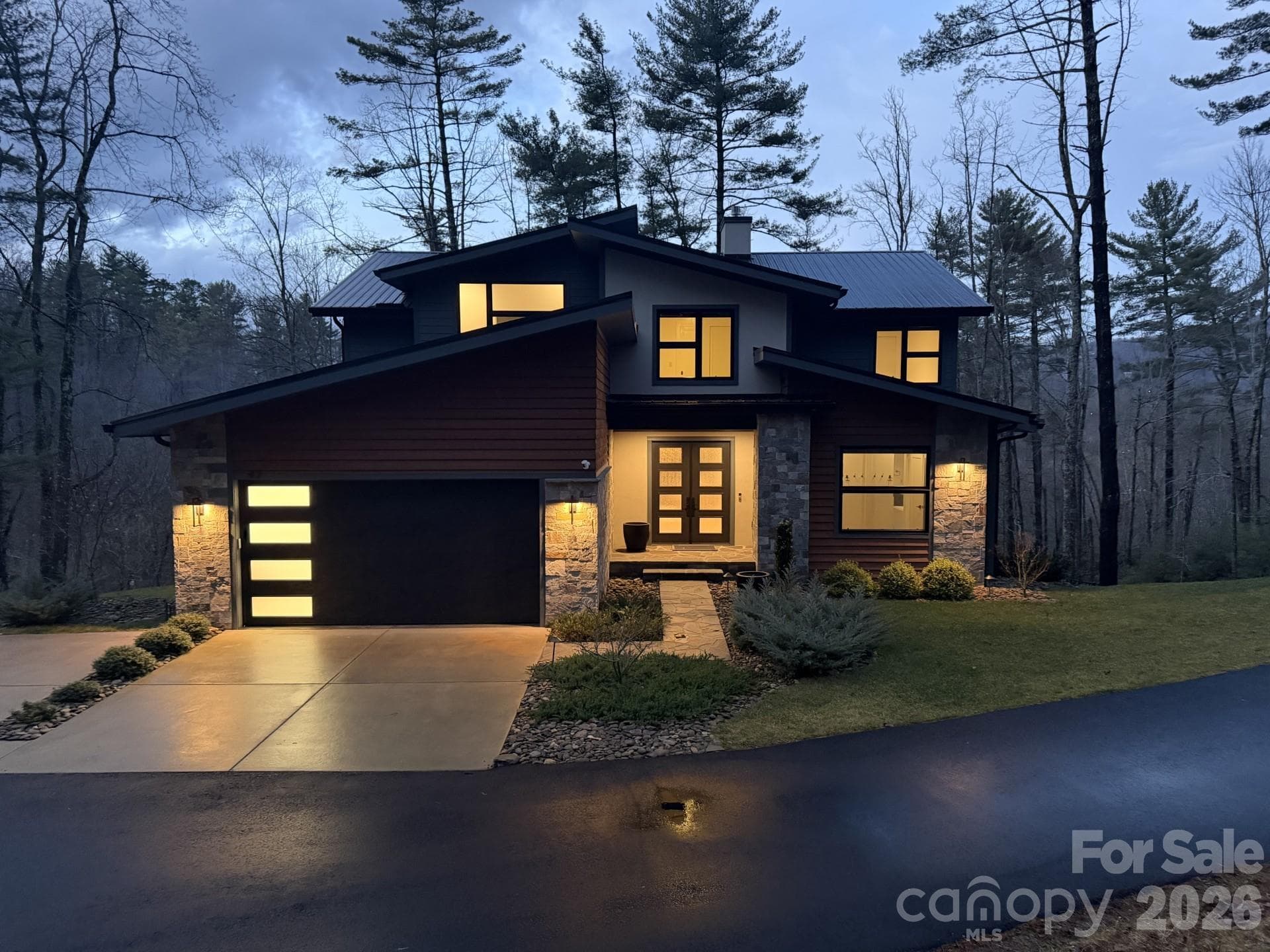 Photo of this incredible home at dusk. The architectural details and modern lines are highlighted differently at all times of day (and night!). - Asheville