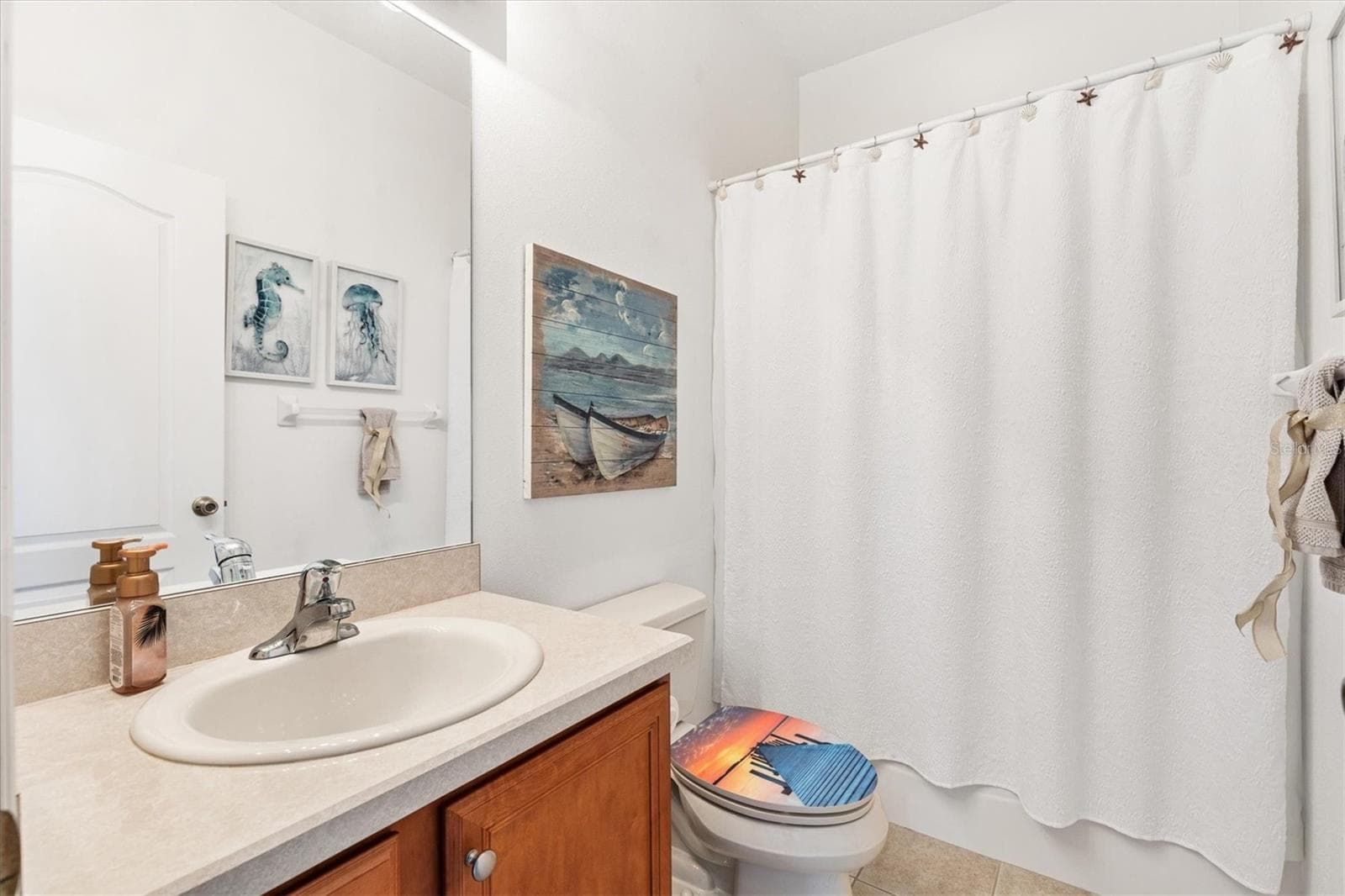The second bathroom features a tub and is conveniently positioned between the second and third bedrooms, as well as the den. - 12107 EAGLE POINT CT, LEESBURG