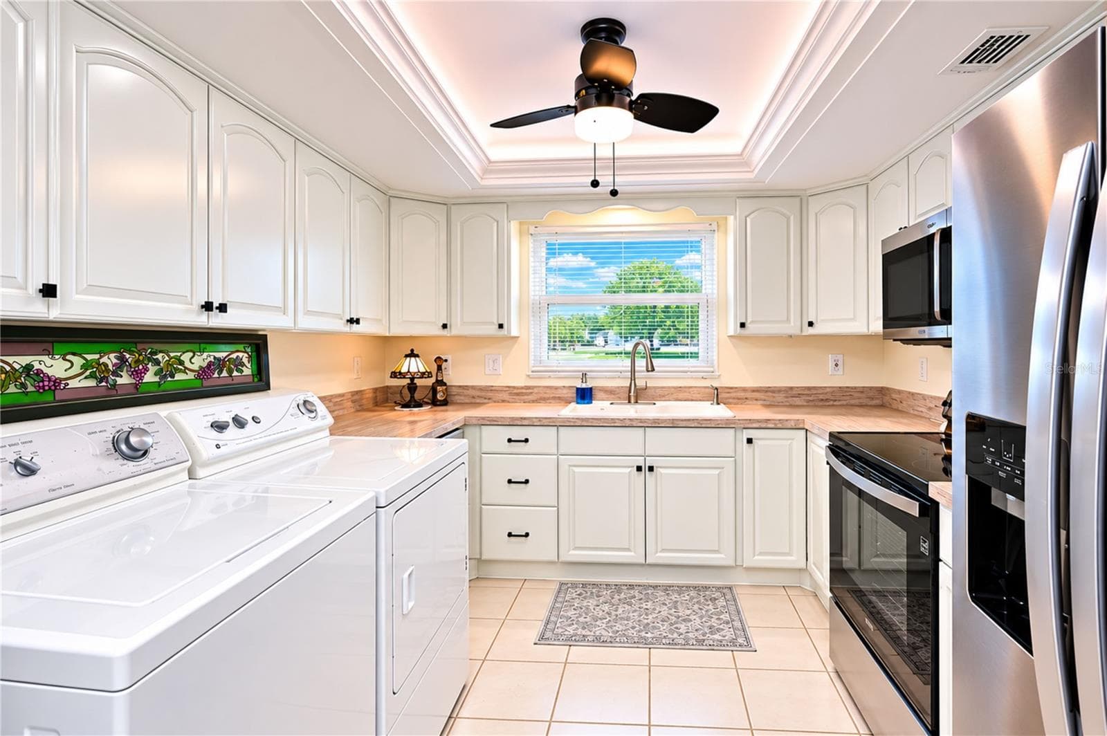 White cabinetry is complimented by the tray ceiling with remote controlled LED lighting - 4853 INDEPENDENCE DR, BRADENTON