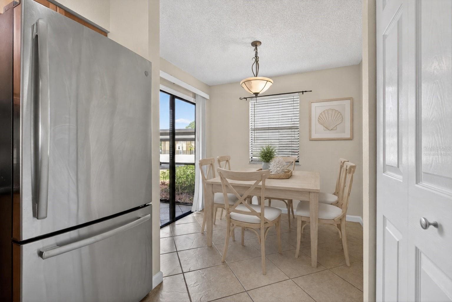 Virtually staged dining room. - 10125 SAILWINDS BLVD N #104, LARGO