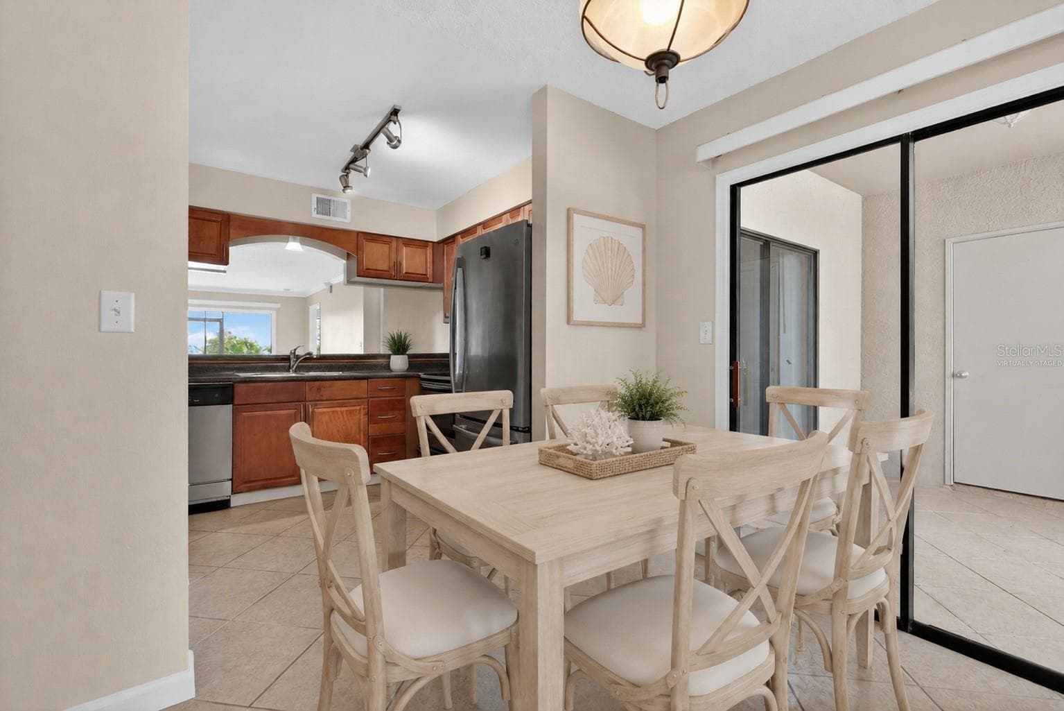 Virtually staged dining room. - 10125 SAILWINDS BLVD N #104, LARGO