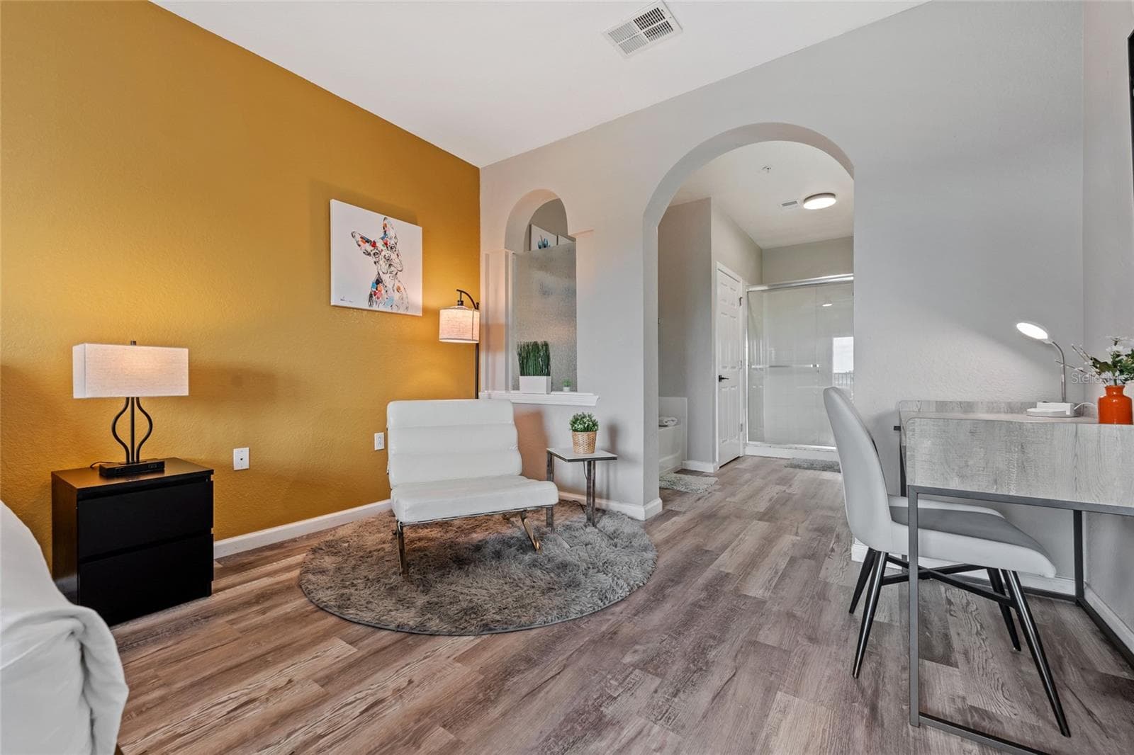 Primary suite, desk, lounge chair, entrance to Ensuite bathroom - 14200 AVALON RD #409, WINTER GARDEN