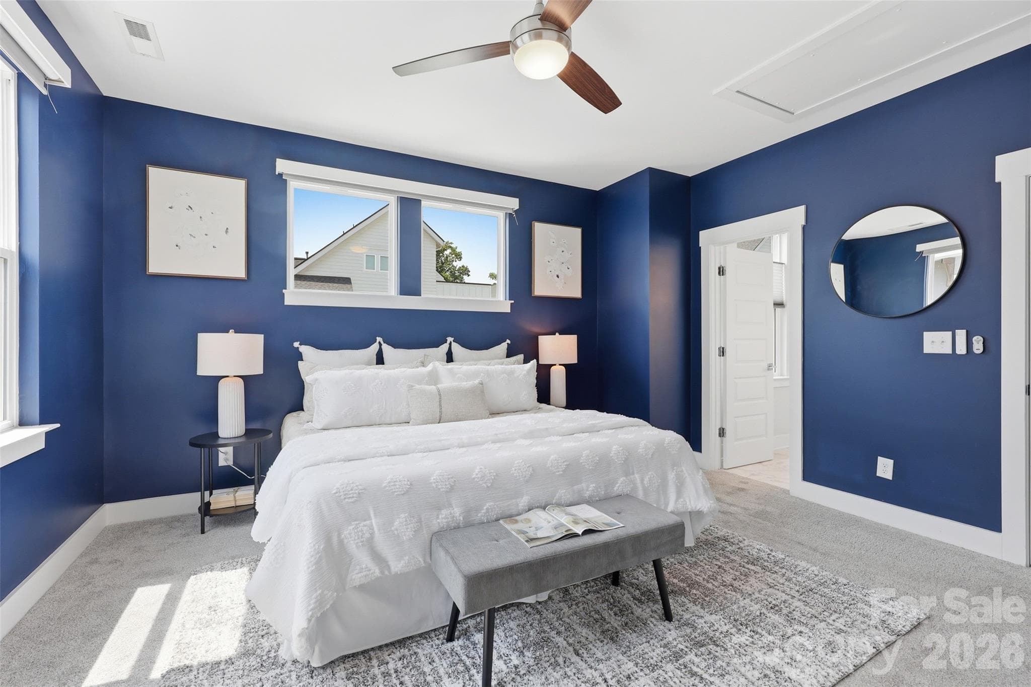 Automatic shades make it easy to control how much light you want in your primary bedroom. - 2148 Electric Lane, Charlotte