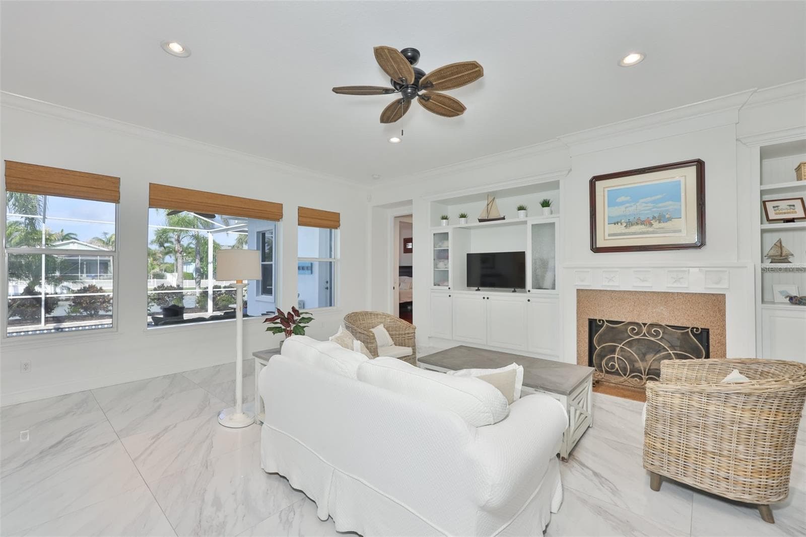 airy family room with built in cabinets and shelving - beadboard accents - 5318 LOON NEST CT, APOLLO BEACH