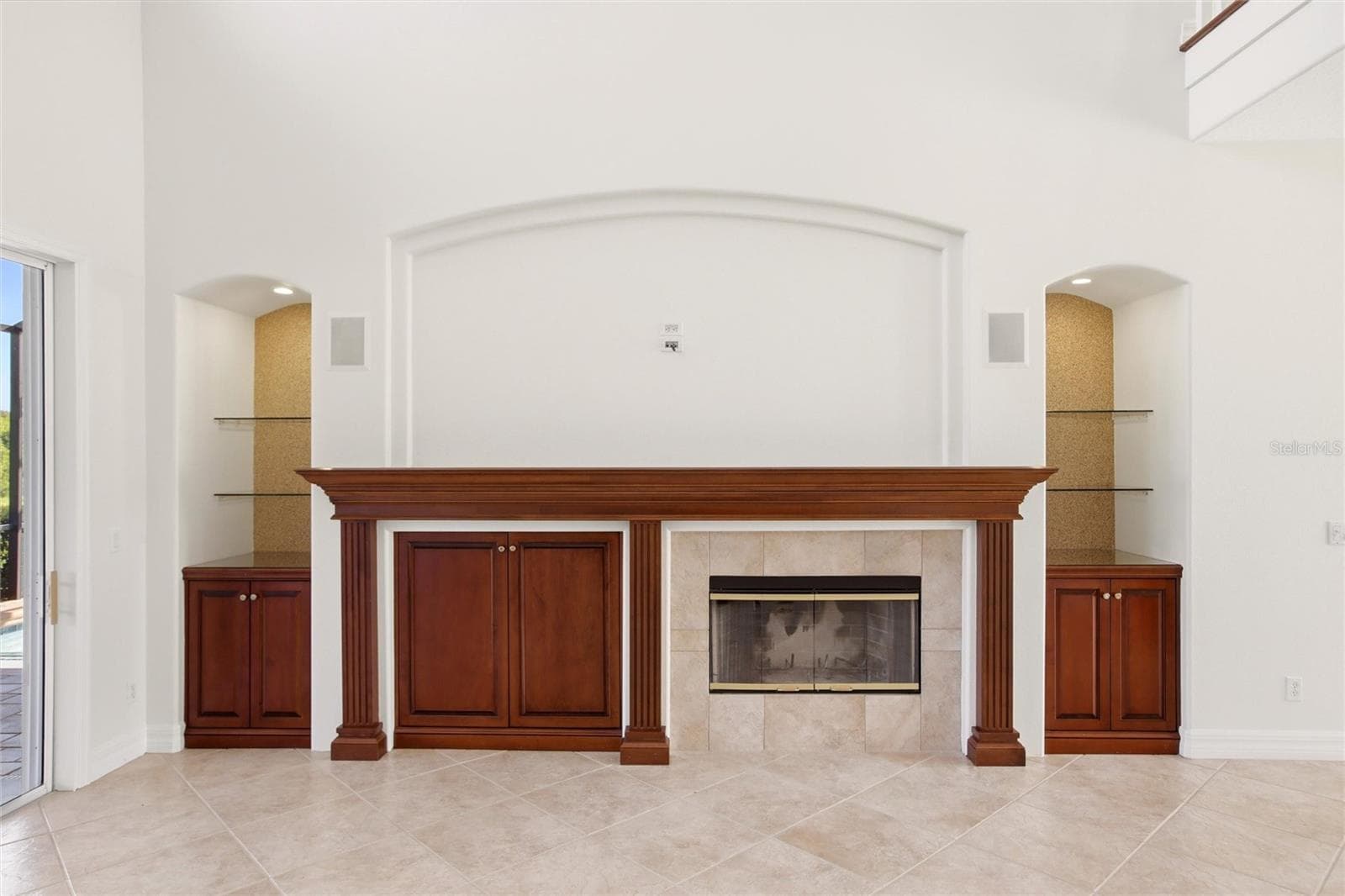 The family room features soaring cathedral ceilings, a fireplace with mantel, and sliding glass doors opening to the lanai, while flowing seamlessly into the kitchen for comfortable everyday living and entertaining. - 8417 LONE EAGLE WAY, SARASOTA