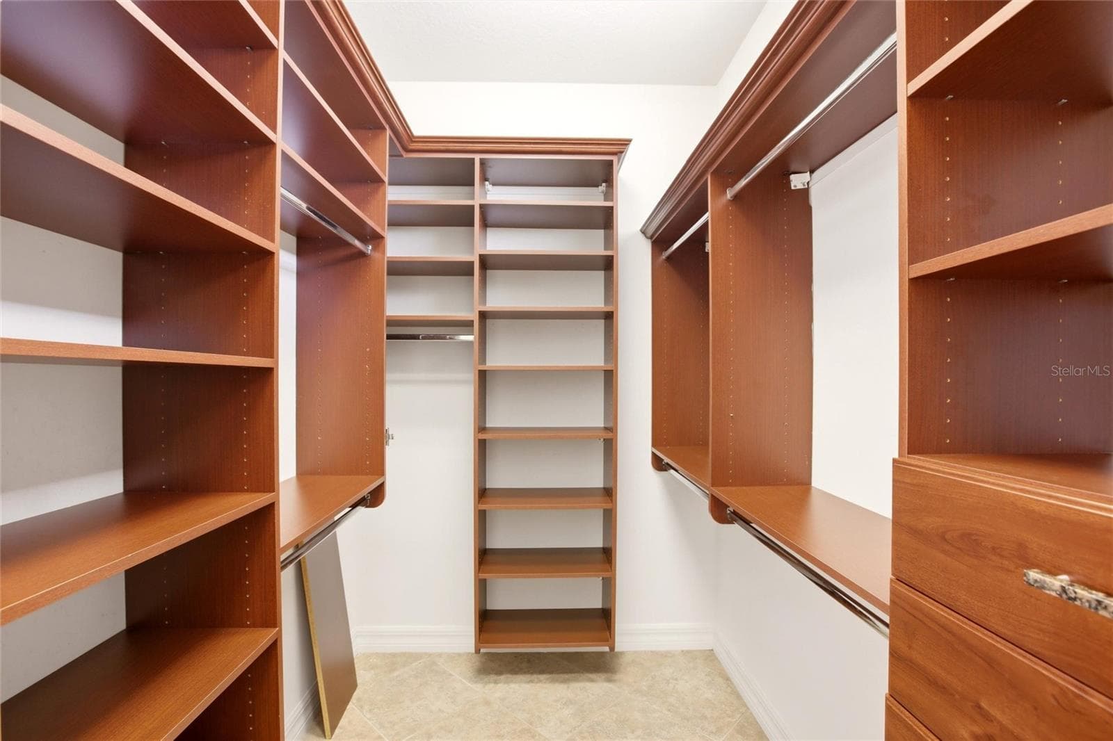 The primary bathroom features a soaking tub, split vanities with dedicated makeup counter space, a spacious walk-in shower with dual shower heads, a private water closet, and dual walk-in closets with custom organization. - 8417 LONE EAGLE WAY, SARASOTA