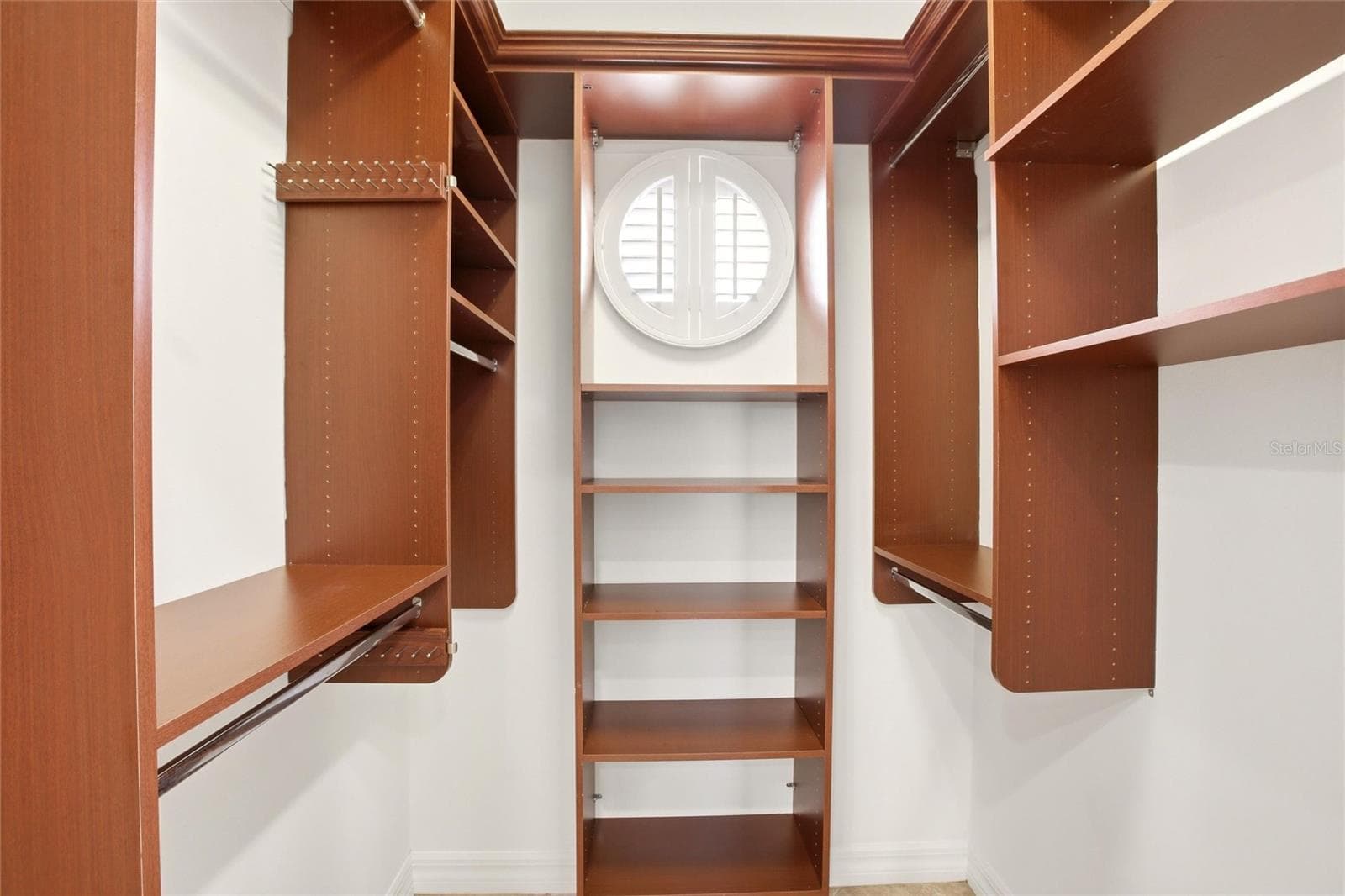 The primary bathroom features a soaking tub, split vanities with dedicated makeup counter space, a spacious walk-in shower with dual shower heads, a private water closet, and dual walk-in closets with custom organization. - 8417 LONE EAGLE WAY, SARASOTA