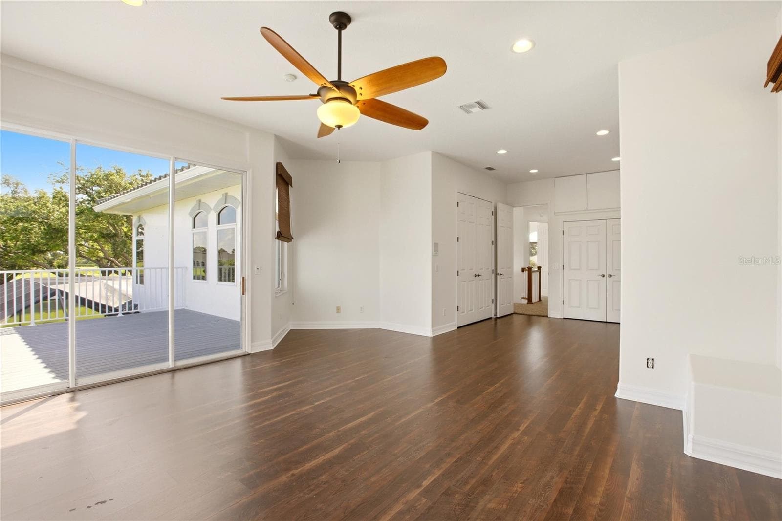 The spacious bonus room offers exceptional versatility, serving as an ideal playroom, guest quarters, media room, or workout space. It is well-appointed with a wet bar, refrigerator, washer and dryer, and a large storage closet, and opens through sliding glass doors to a private second-floor balcony overlooking the lake and golf course. A dumbwaiter provides convenient access from the kitchen below. - 8417 LONE EAGLE WAY, SARASOTA