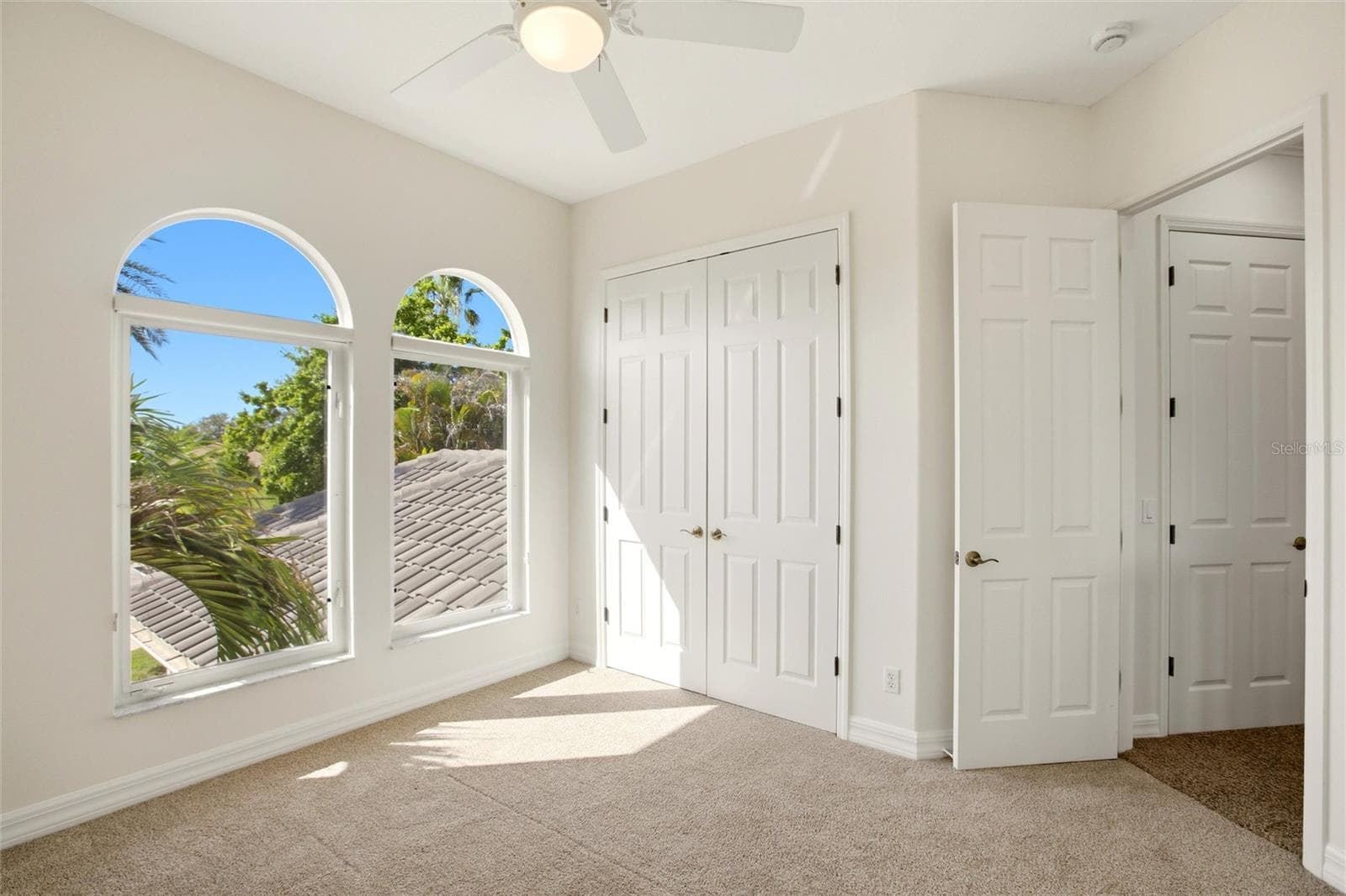 The bedroom features a built-in closet and convenient access to a nearby hall bathroom. - 8417 LONE EAGLE WAY, SARASOTA