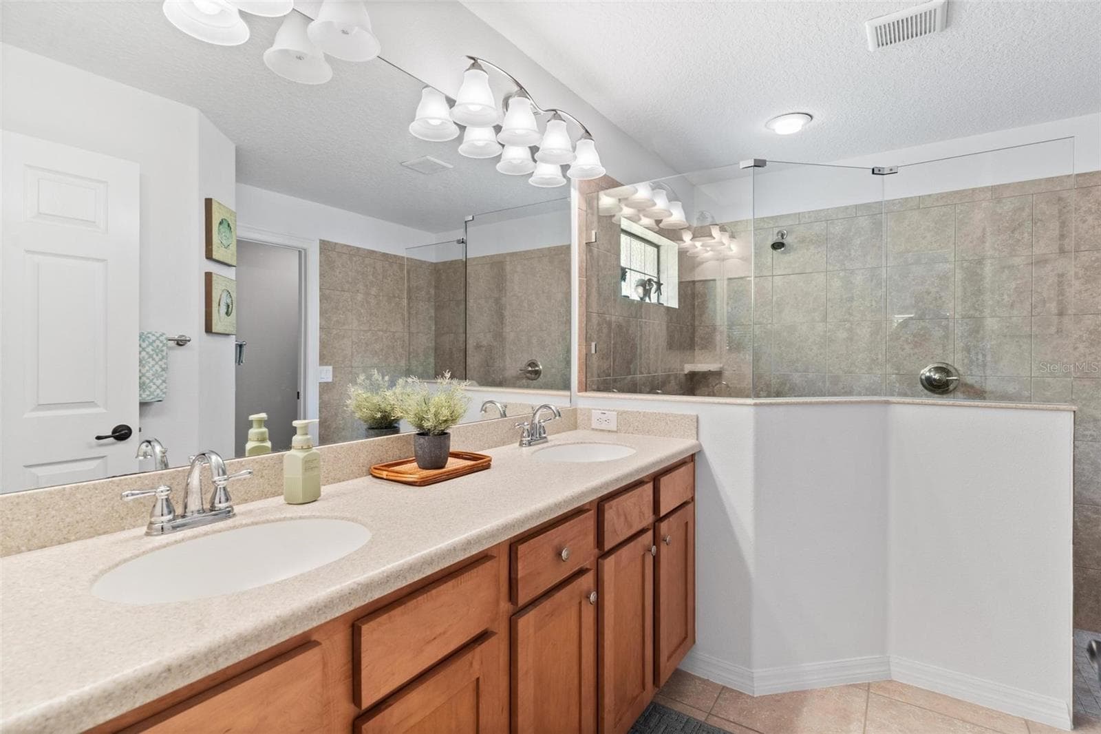 Primary Bath with dual sinks built in Corian Countertops... - 6115 LANDINGS BLVD, LADY LAKE