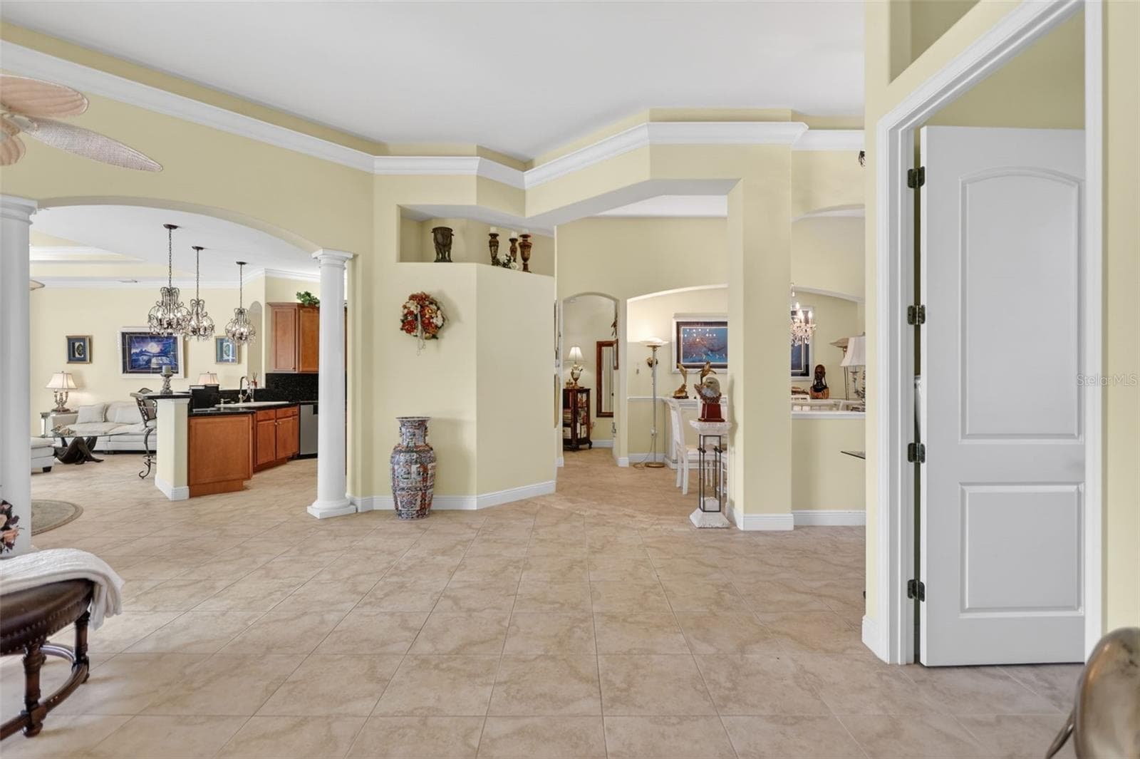 Grand interior spaces showcase soaring 14-foot ceilings, extensive crown molding, custom architectural details, and tile flooring throughout. - 1210 408TH CT E, MYAKKA CITY