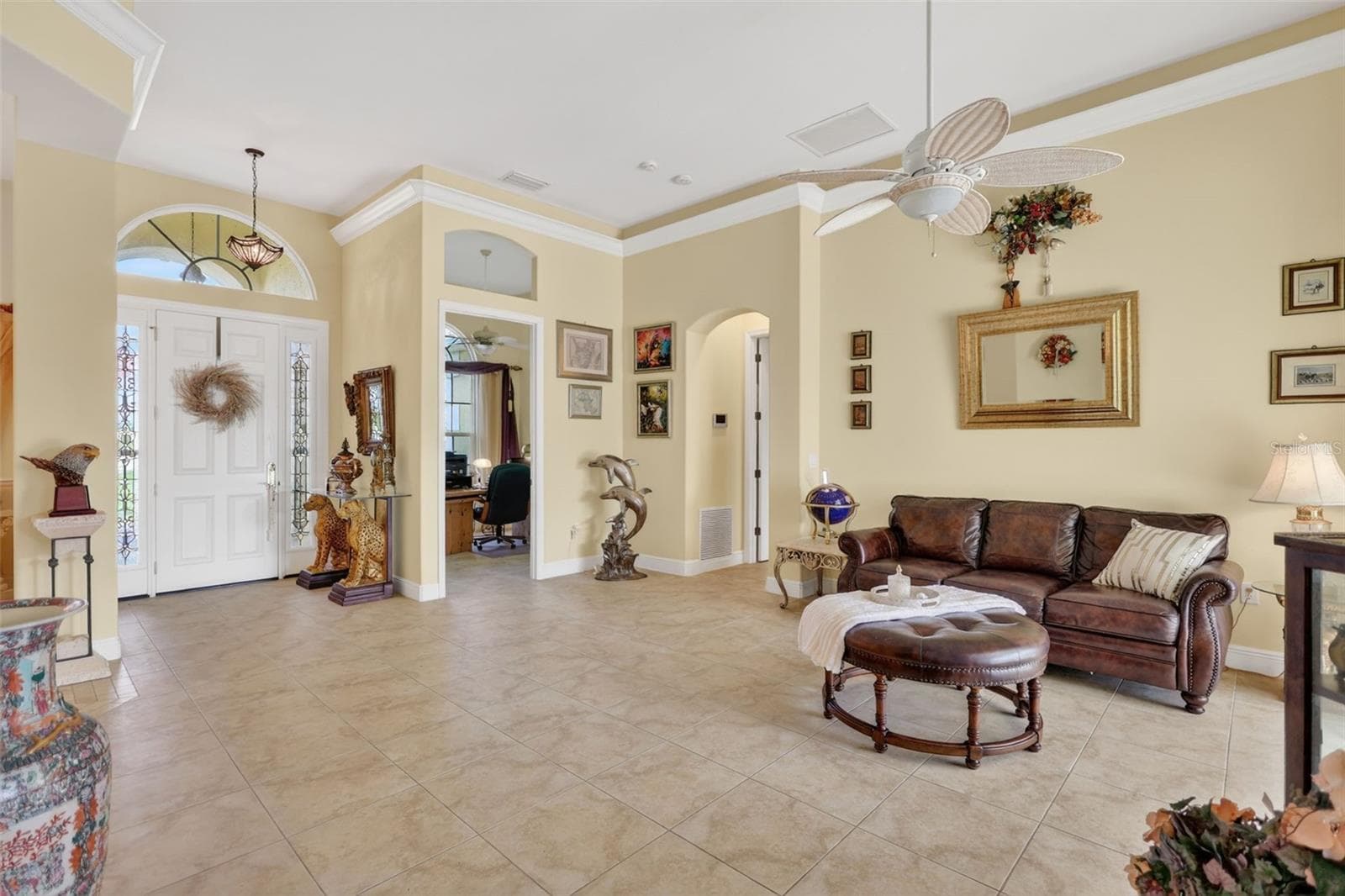 The spacious kitchen offers abundant cabinetry, extensive workspace, a center island, breakfast bar seating, and seamless connectivity to the home's main living areas. - 1210 408TH CT E, MYAKKA CITY