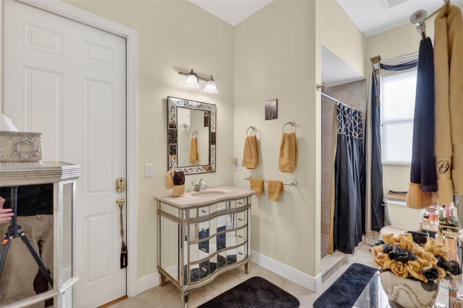 The well-appointed pool bath features attractive finishes and direct access, creating a seamless transition between indoor and outdoor living. - 1210 408TH CT E, MYAKKA CITY