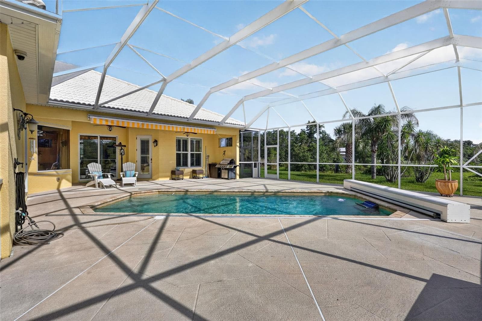 The oversized pool deck offers abundant room for entertaining, relaxing, and enjoying the peaceful natural surroundings. - 1210 408TH CT E, MYAKKA CITY