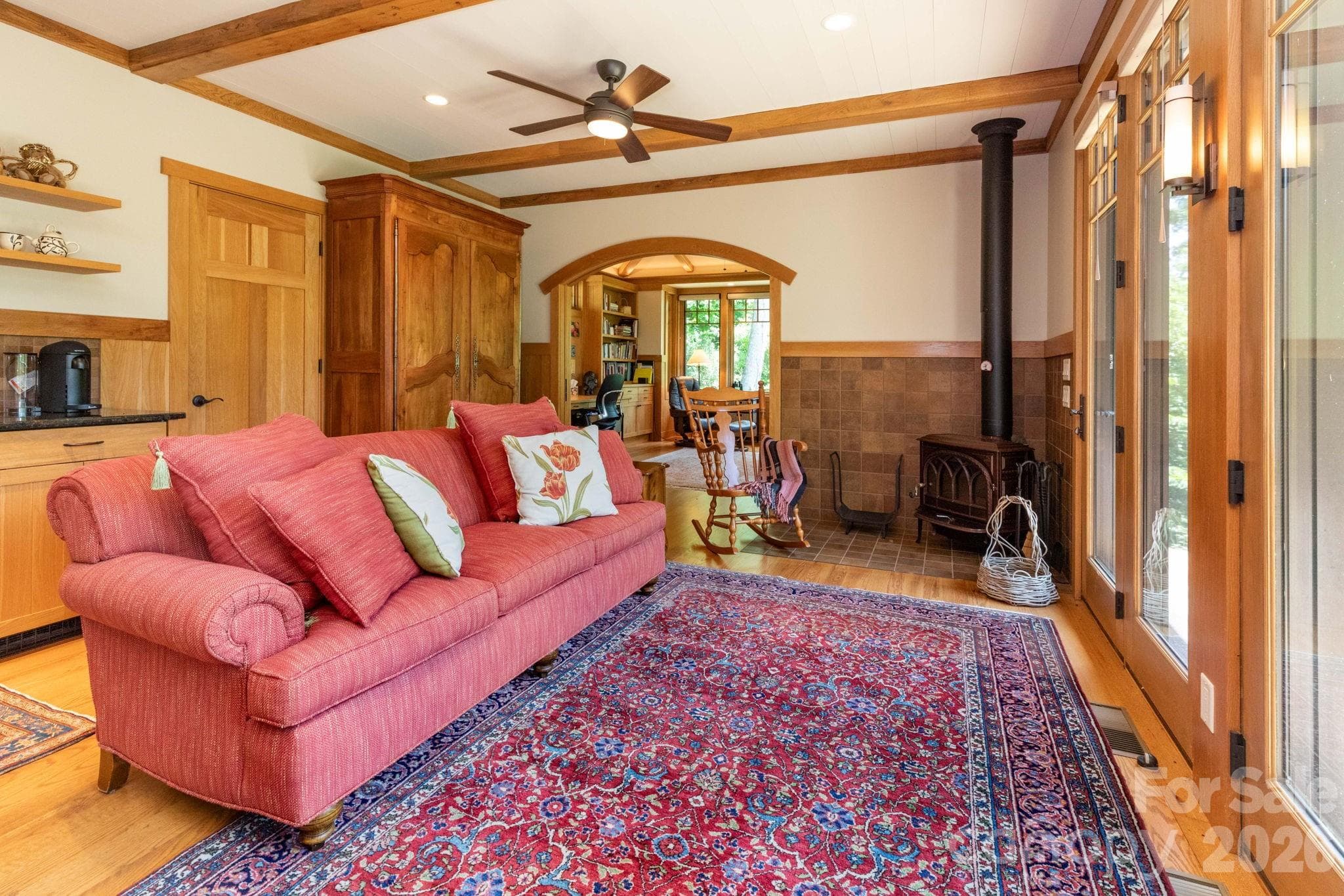 Guest House. Cozy sitting area anchored by a wood stove, creating a warm and inviting atmosphere perfect for relaxing mountain evenings. - 29 Gardner Drive, Asheville