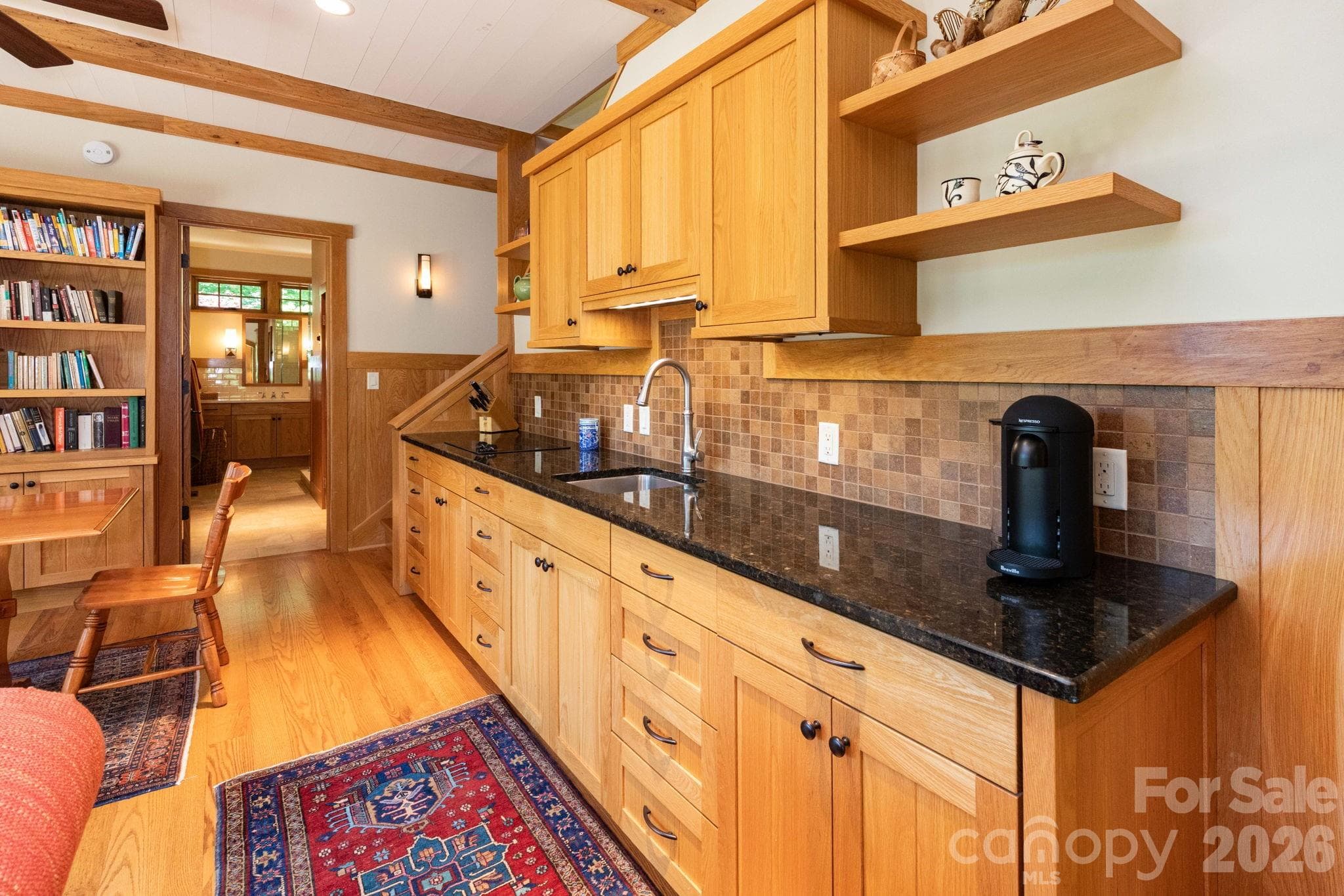 Guest House. Well-appointed kitchenette with custom cabinetry, granite countertops, tile backsplash, and open shelving for both beauty and functionality. - 29 Gardner Drive, Asheville