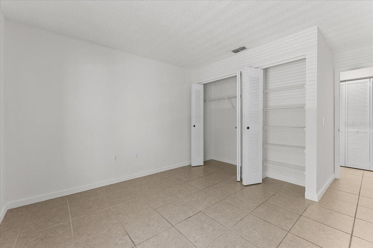 Bedroom 2 with dual closets - 3001 58TH AVE S #1106, ST PETERSBURG