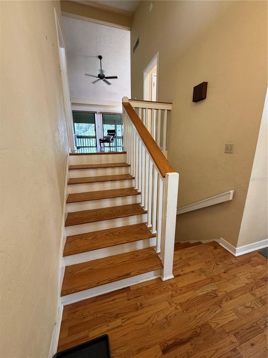 Stairway to living/kitchen/dining area - 8 CANTERBURY DR, HAINES CITY