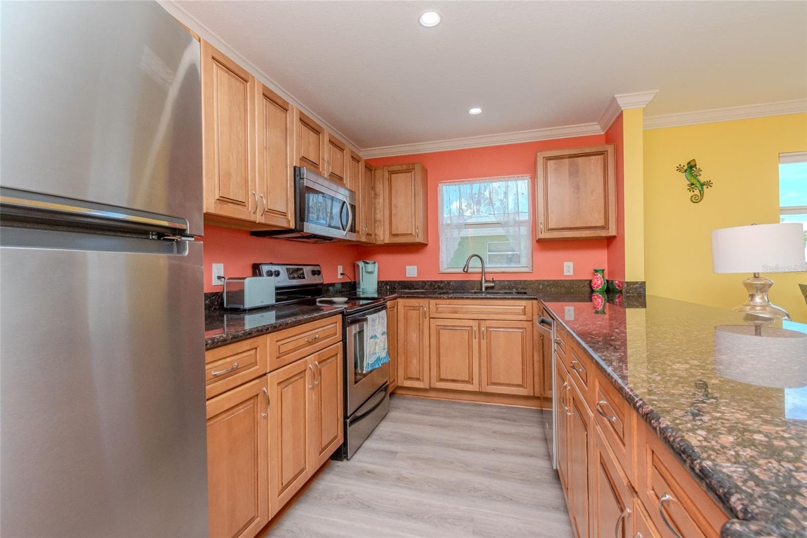 LOTS OF CUPBOARDS IN THE WRAP AROUND KITCHEN - 5605 SHORE BLVD S #1B, GULFPORT