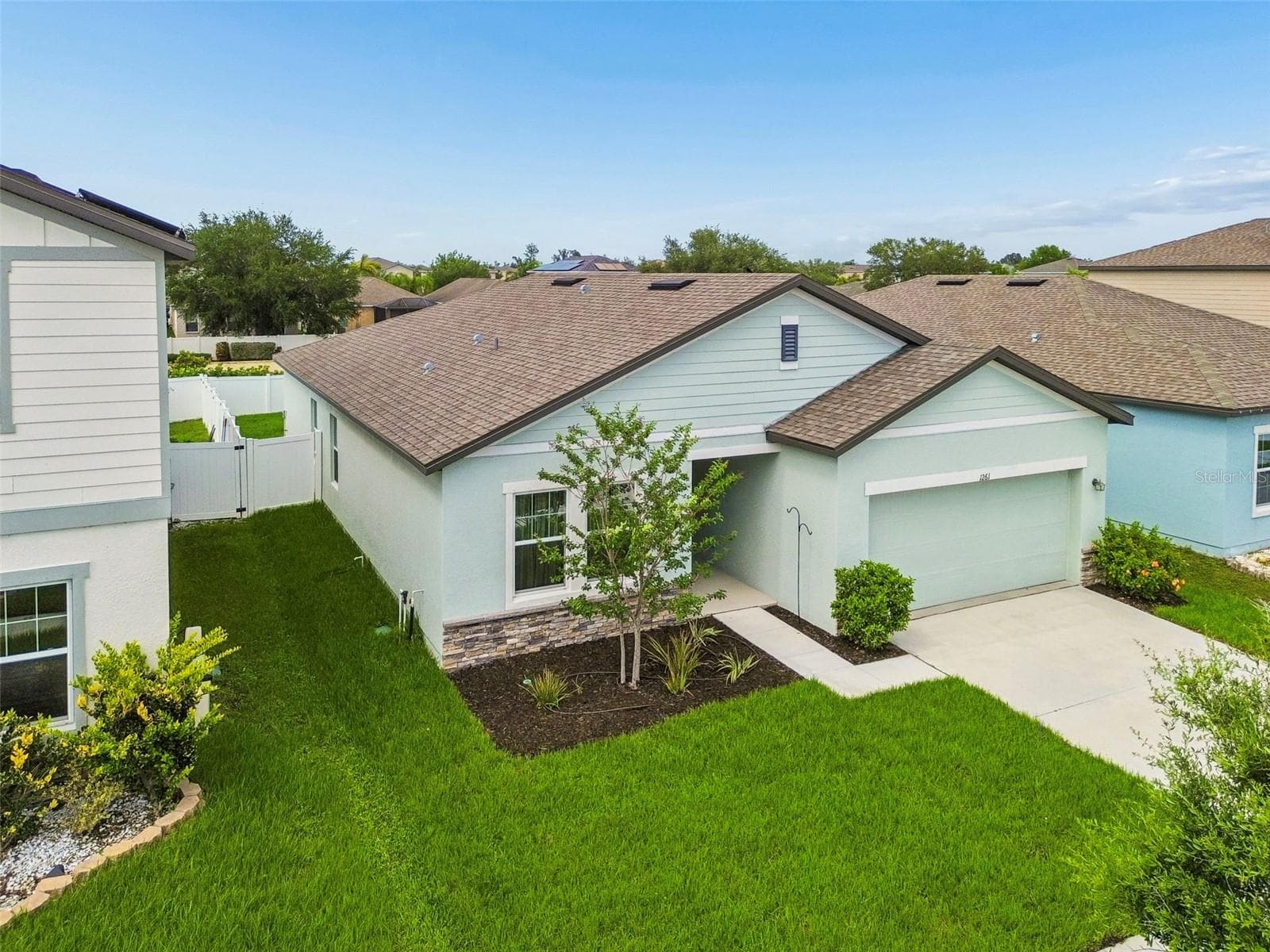 Beautiful modern curb appeal! Featuring contrasting dark trim, stone accents, and meticulously maintained lawn! - 1261 ANCHOR BEND DR, RUSKIN
