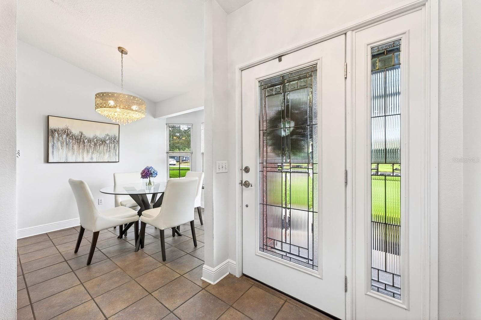 Step through the elegant ETCHED-GLASS FRONT DOOR with matching sidelight and immediately notice the STUNNING CHANDELIER (2021). - 2706 HARGILL DR, ORLANDO