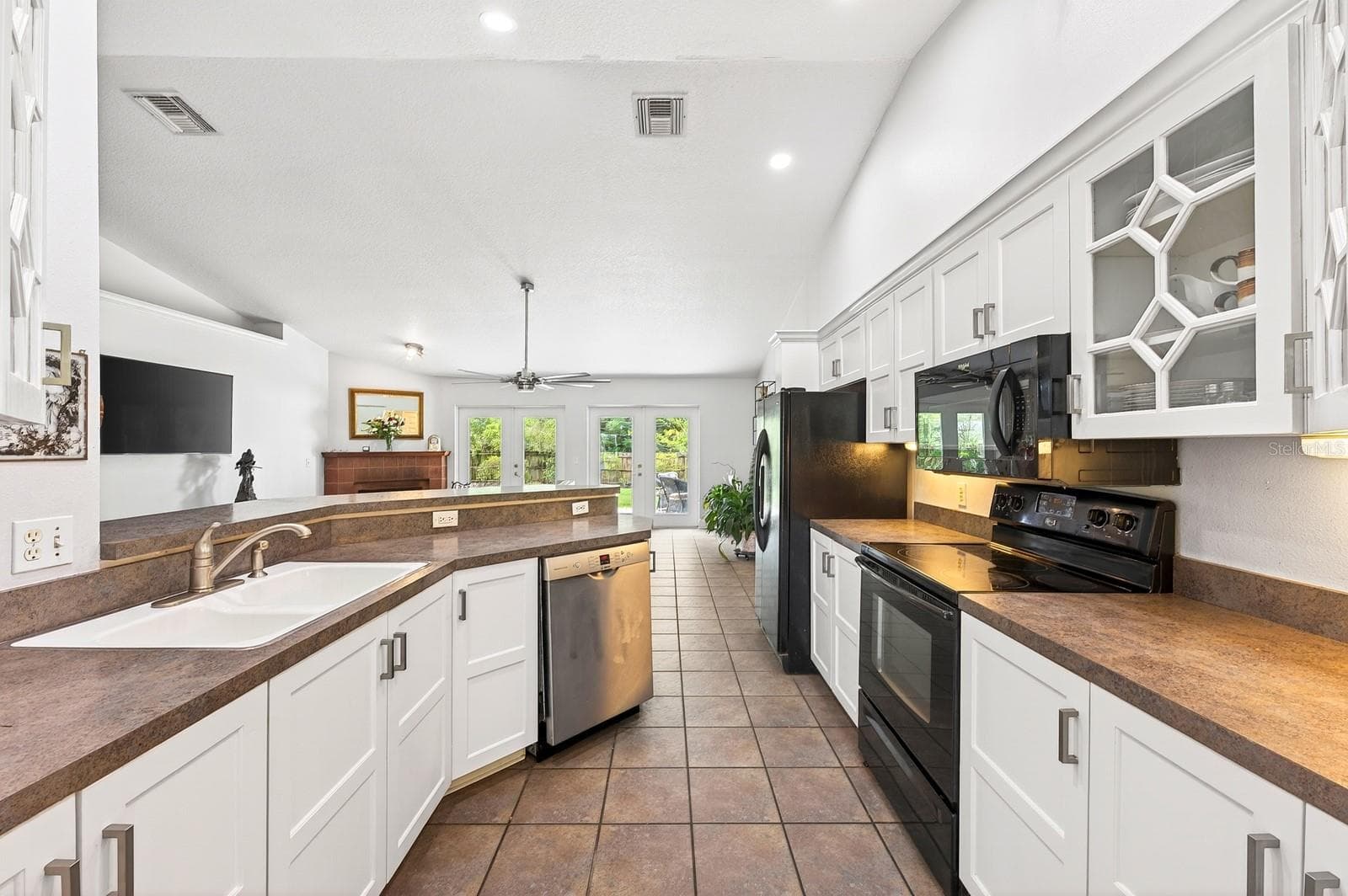 A BOSCH DISHWASHER (2021), breakfast bar seating, and a walk-in pantry offer both style and functionality to the Kitchen. - 2706 HARGILL DR, ORLANDO