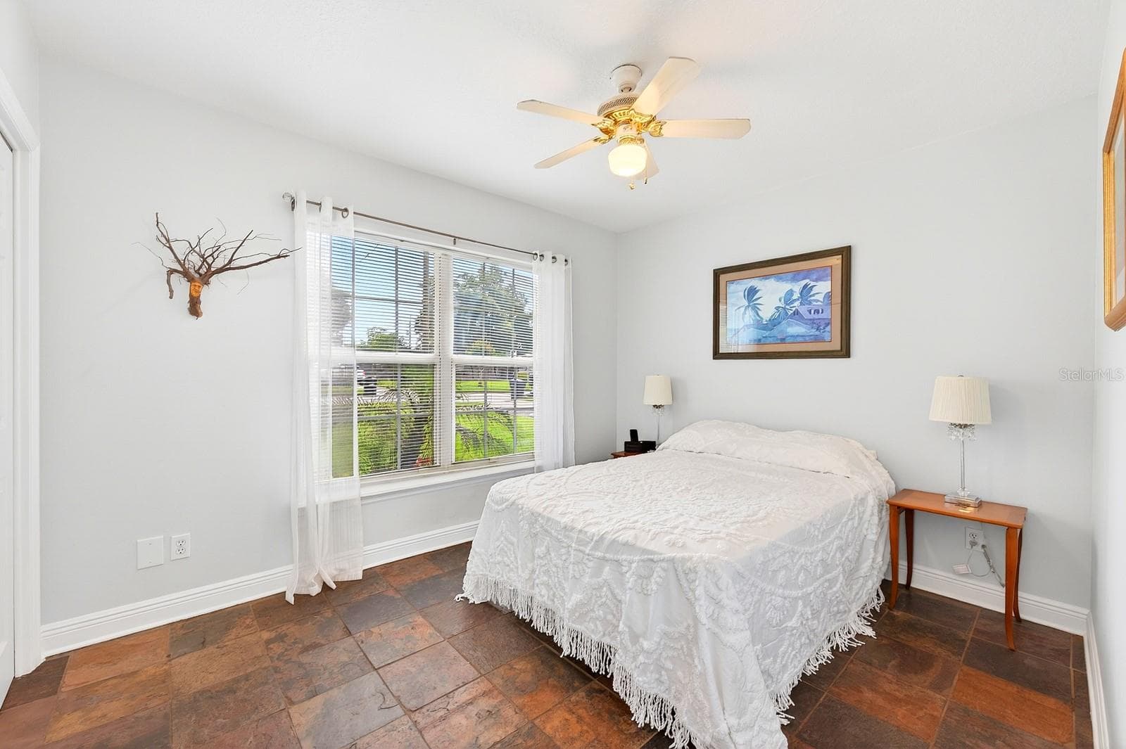 Two additional bedrooms provide flexibility for family, guests, or a home office—one featuring distinctive SLATE FLOORING (2018) and the other WARM WOOD FLOORING—both conveniently located near the second full bath. Bedroom 2 - 2706 HARGILL DR, ORLANDO