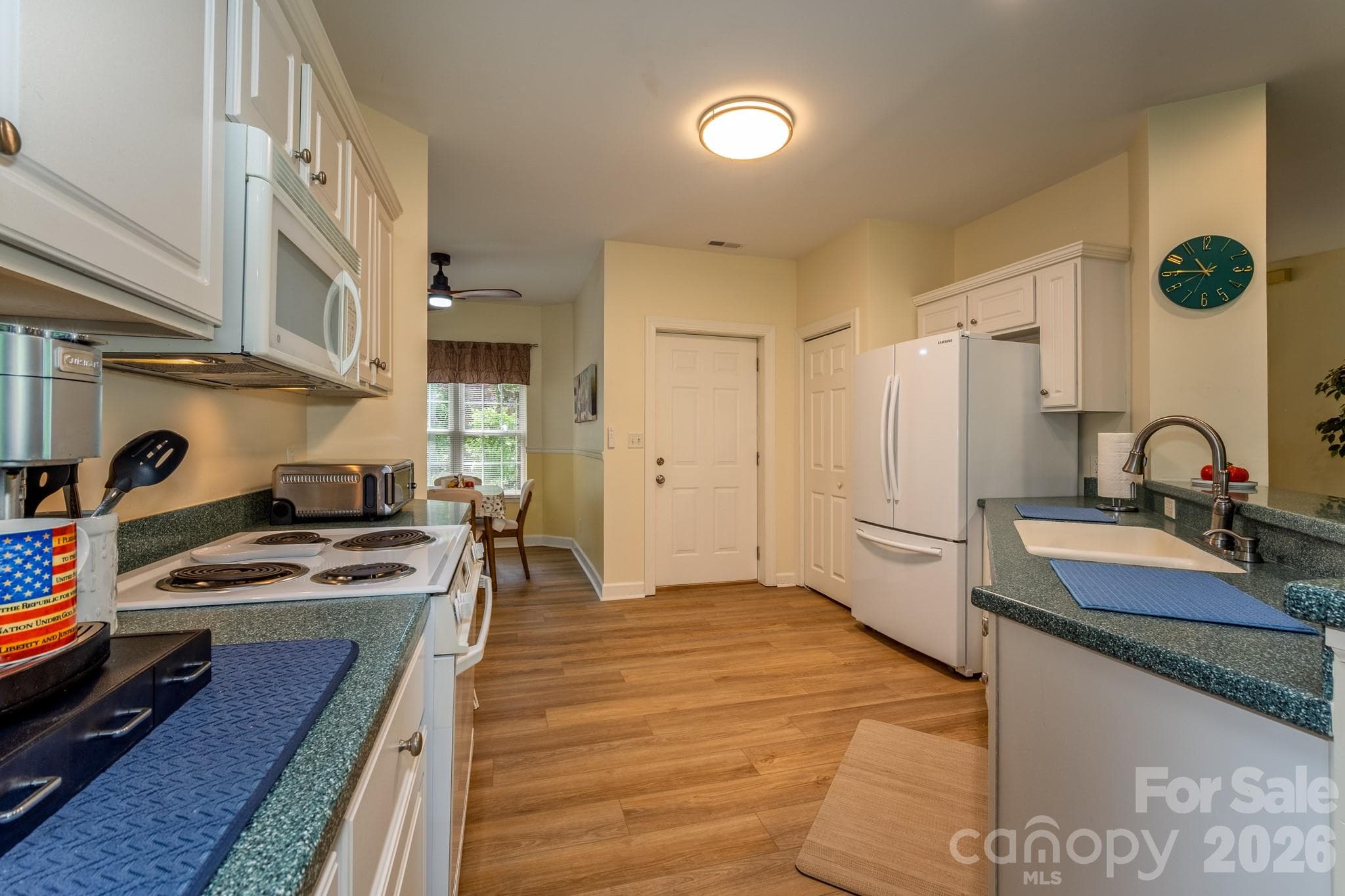 Well-Appointed Kitchen – Bright kitchen with plentiful cabinetry, pantry storage, and a functional layout opening to the dining area. - 99 Ridgetop Circle, Brevard