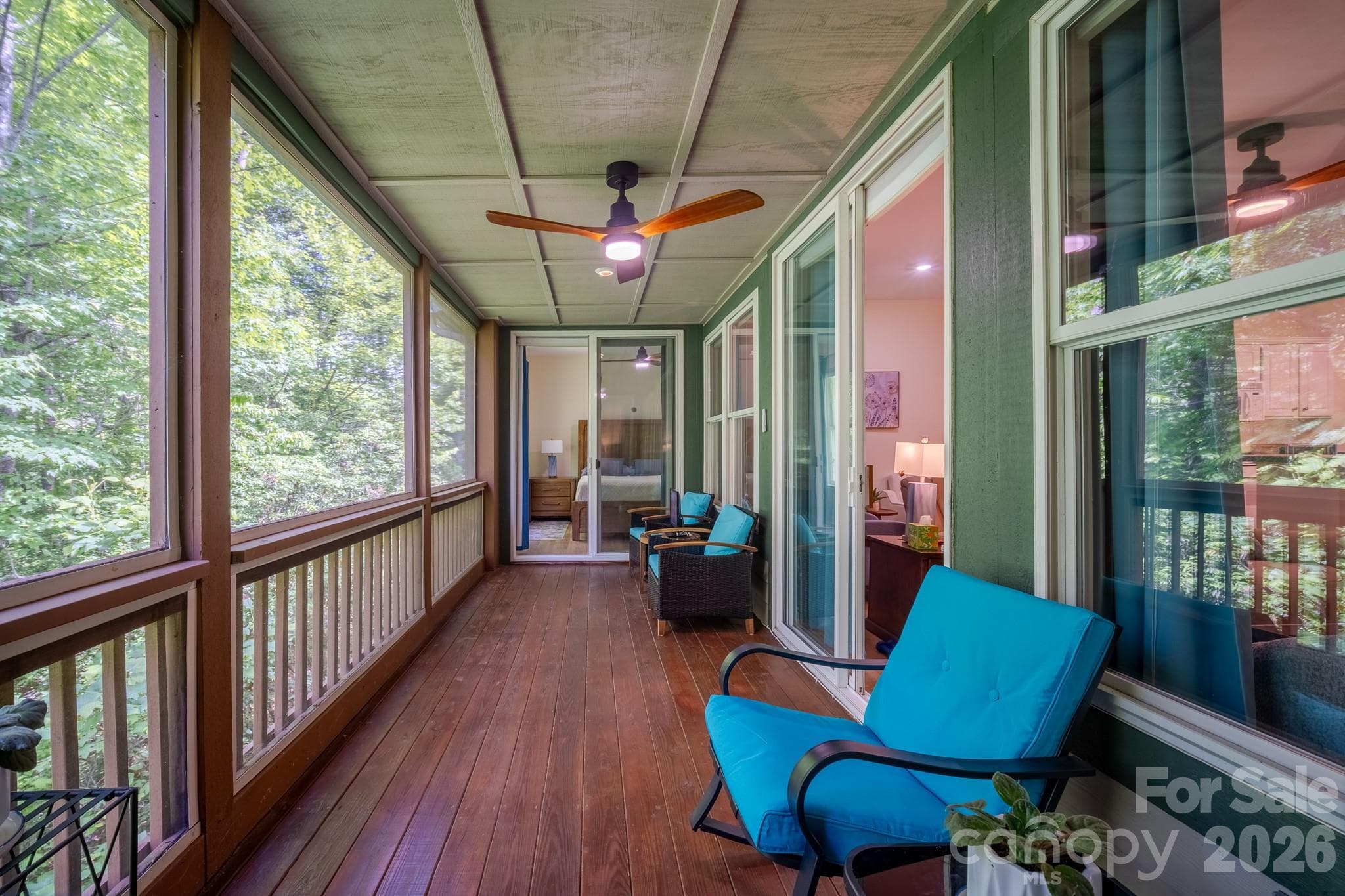 Expansive Screened Porch Retreat – Spacious screened porch offering peaceful wooded privacy, ceiling fan, and plenty of room for relaxing or entertaining in a serene outdoor setting. - 99 Ridgetop Circle, Brevard