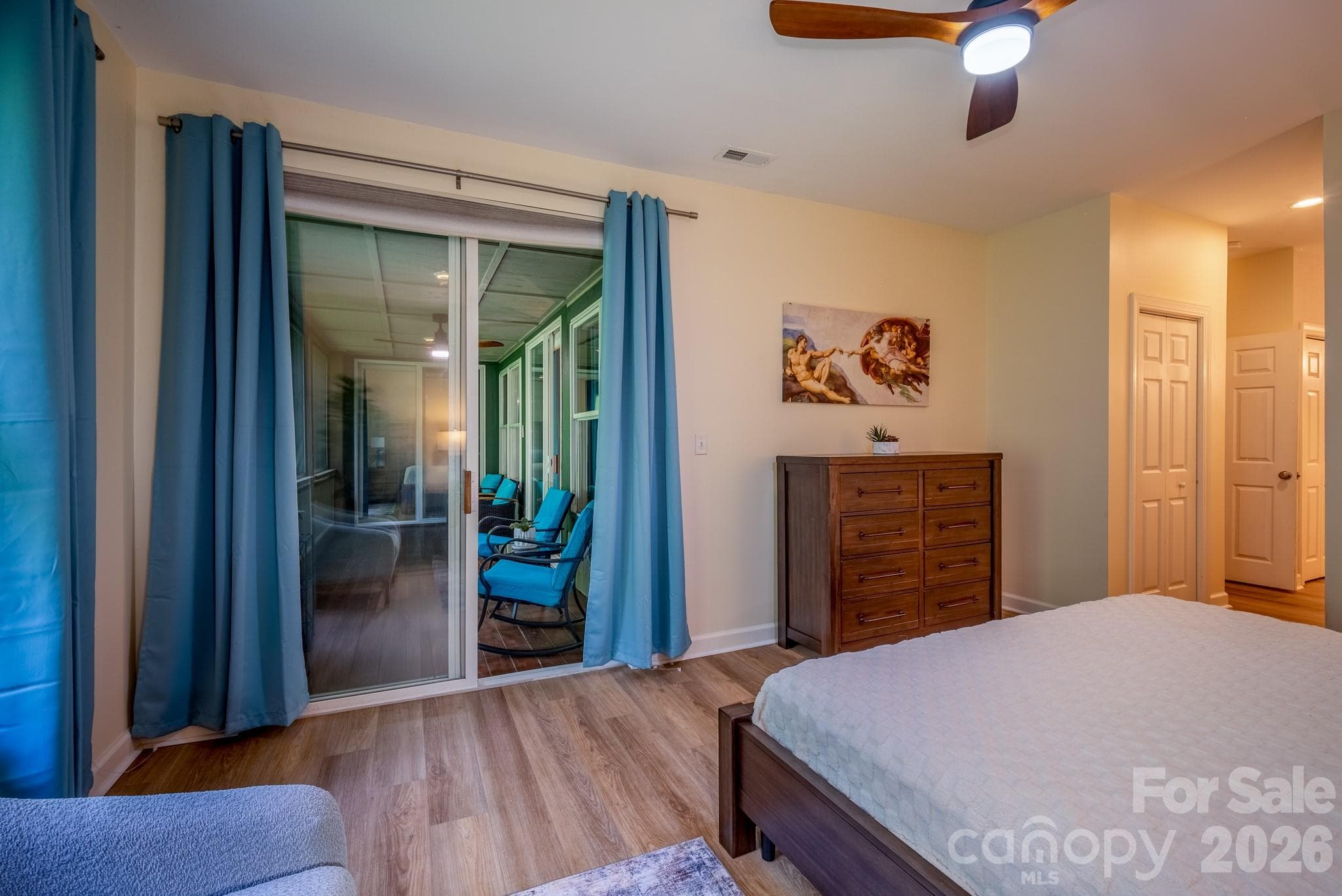 Primary Suite with Screened Porch Access – Comfortable primary bedroom with direct access to the screened porch, creating a seamless indoor-outdoor retreat. - 99 Ridgetop Circle, Brevard