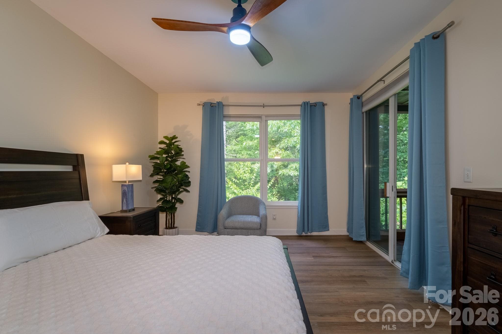 Primary Suite with Screened Porch Access – Comfortable primary bedroom with direct access to the screened porch, creating a seamless indoor-outdoor retreat. - 99 Ridgetop Circle, Brevard