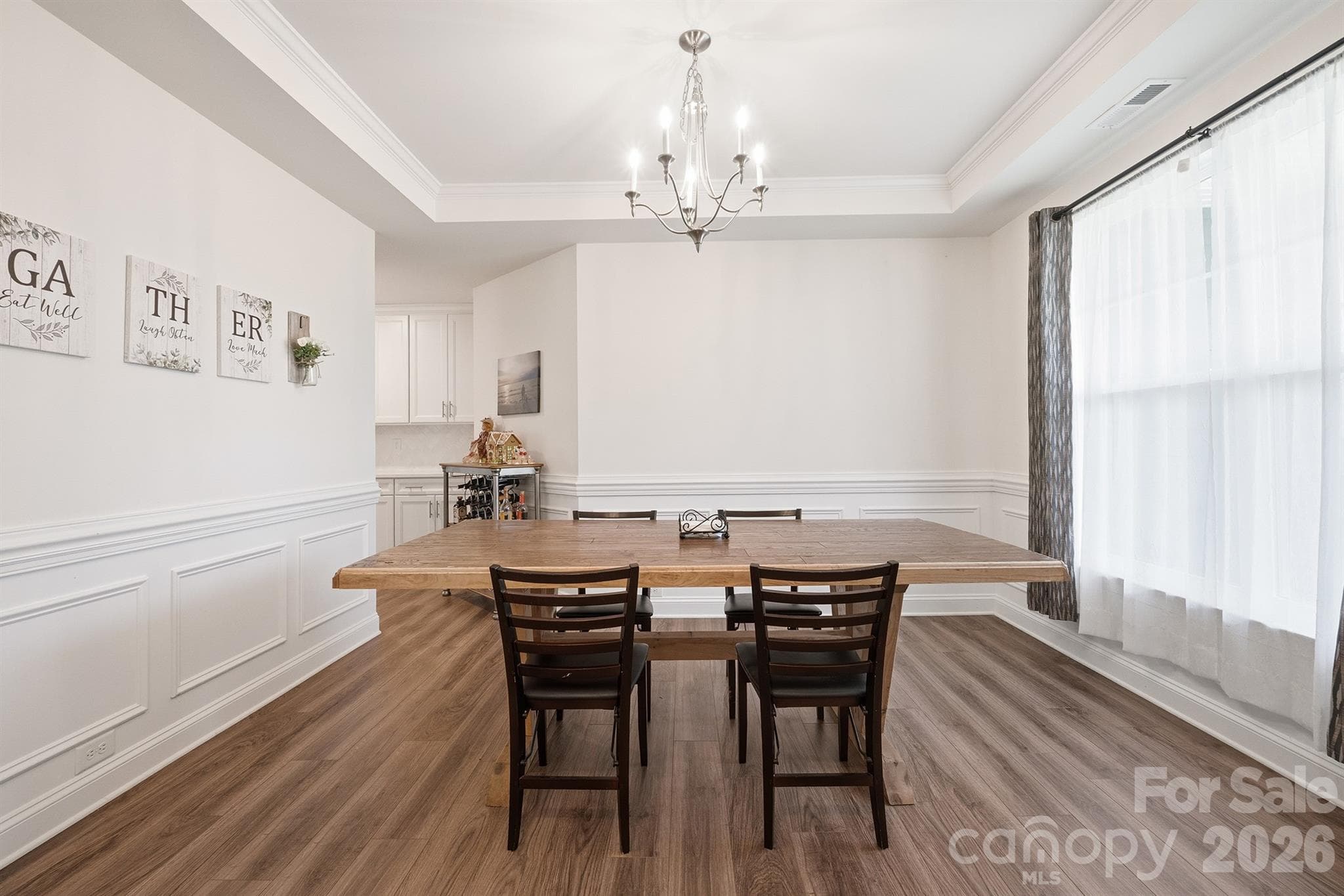 Dining Room Featuring Tray Ceilings and Wainscoting - Waxhaw