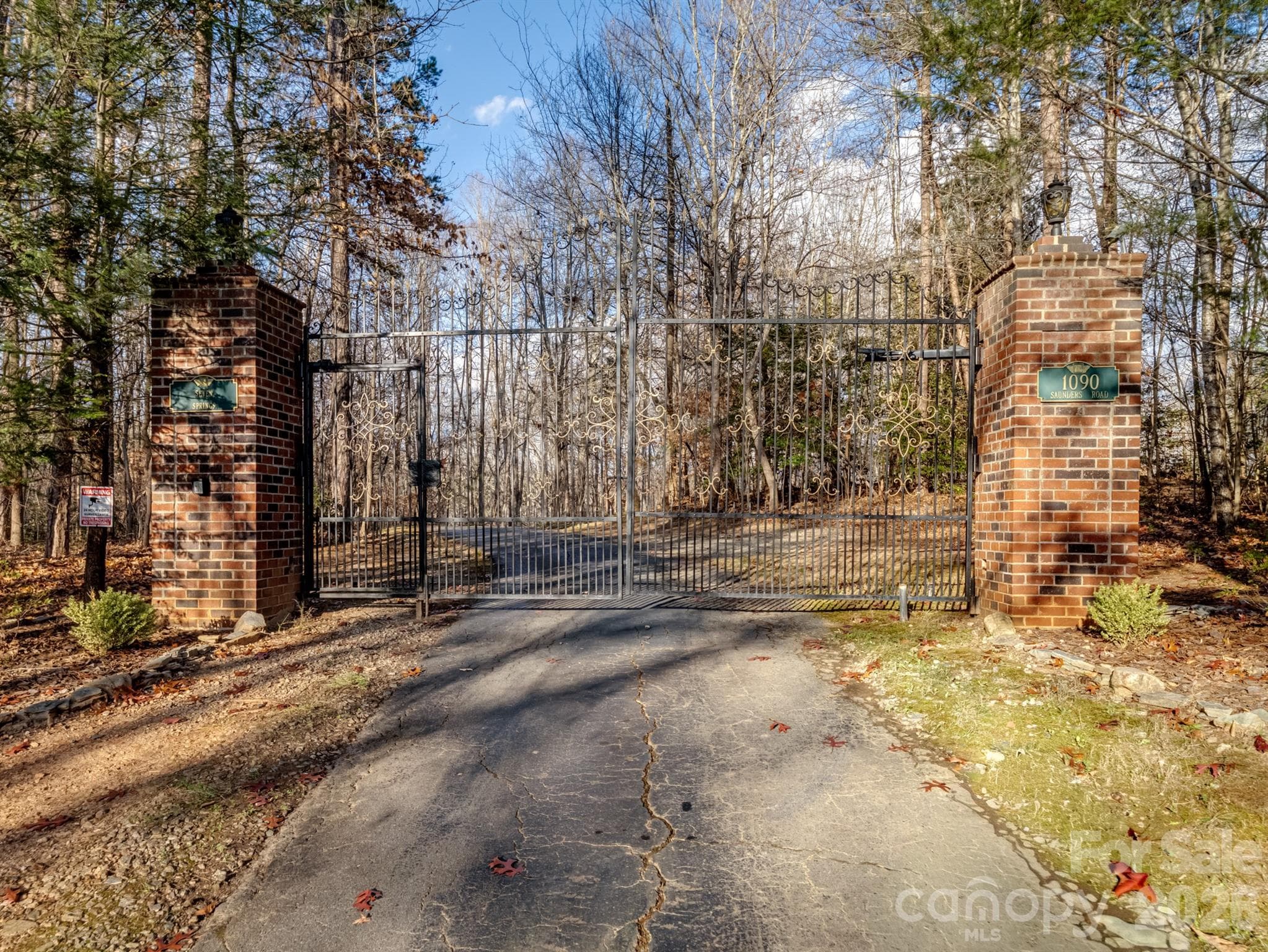 The front entrance is gated, offering peace of mind and a private retreat. The gate, imported from England, exudes timeless elegance. - 1090 N Saunders Drive, Catawba