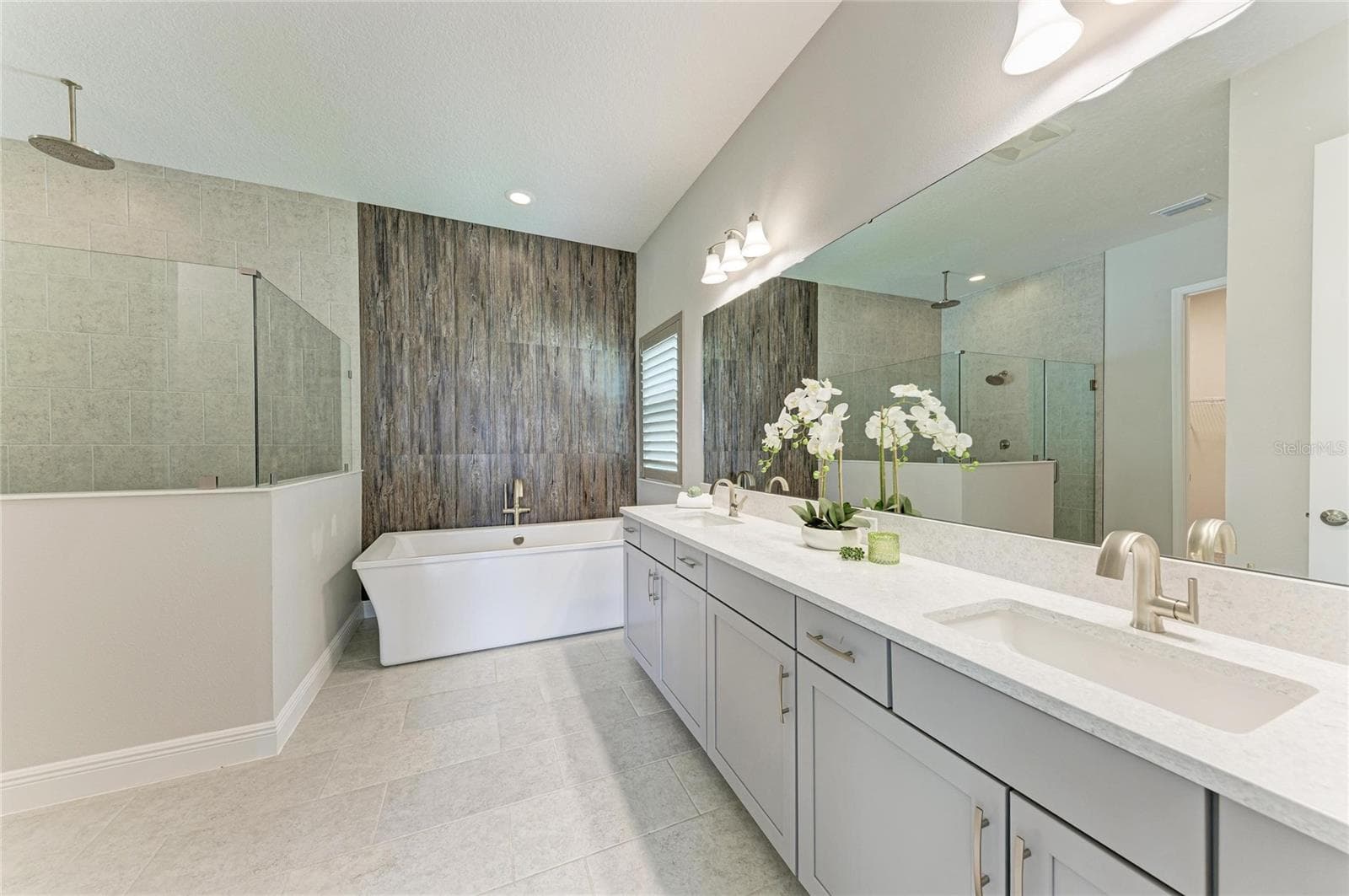 Spa-inspired bath with dual vanities, soaking tub, and oversized walk-in shower - 17725 ROOST PL, LAKEWOOD RANCH