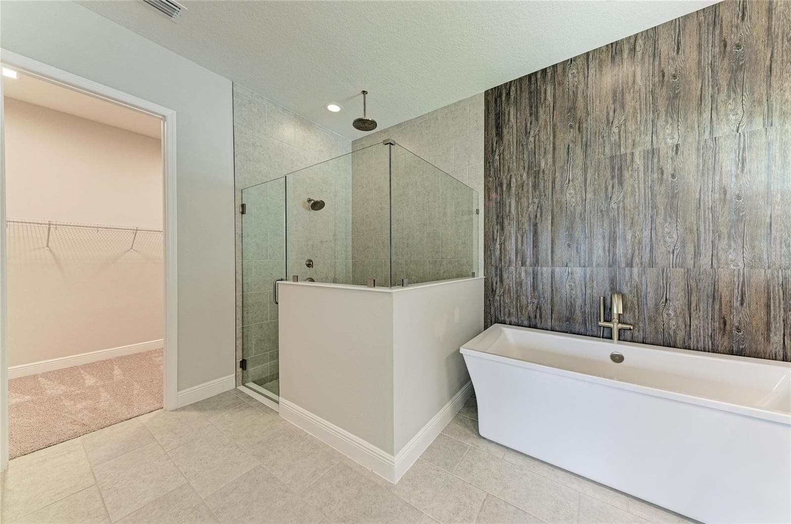Relaxing oversized shower featuring a rainfall showerhead and designer finishes - 17725 ROOST PL, LAKEWOOD RANCH
