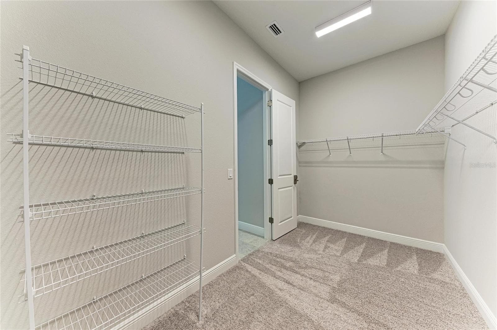 Expansive walk-in closet with abundant storage and organization space - 17725 ROOST PL, LAKEWOOD RANCH
