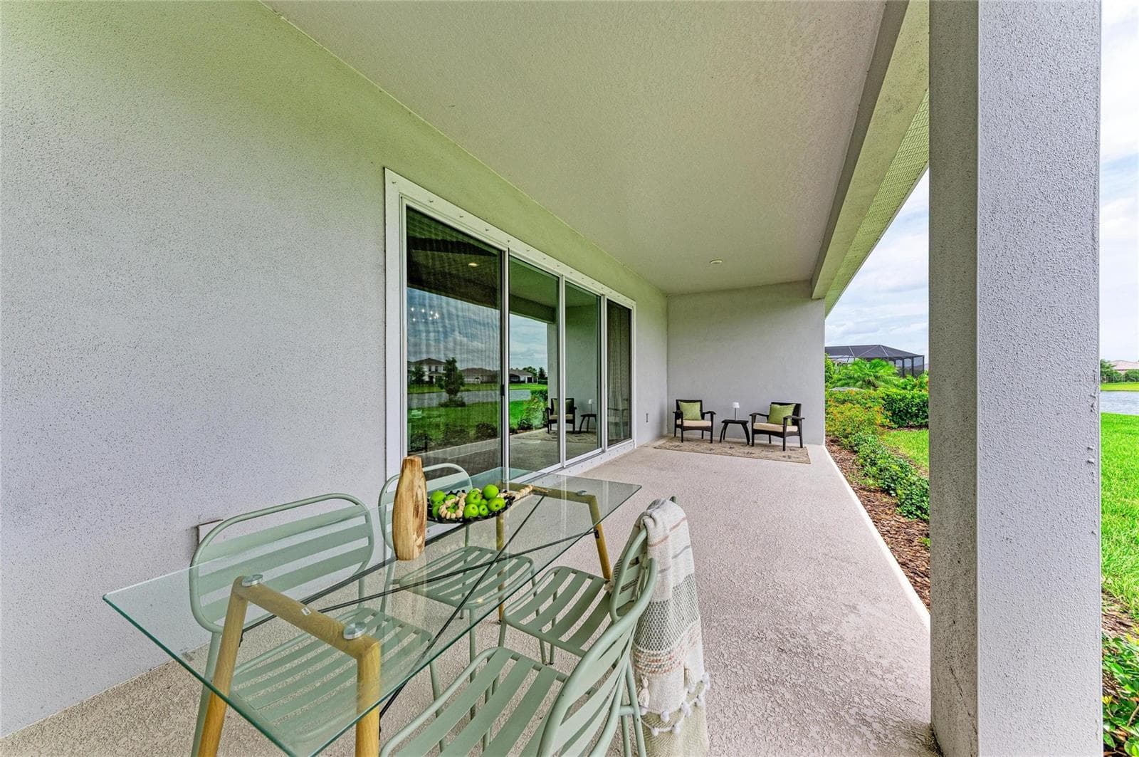 Covered outdoor living space designed for year-round Florida enjoyment - 17725 ROOST PL, LAKEWOOD RANCH