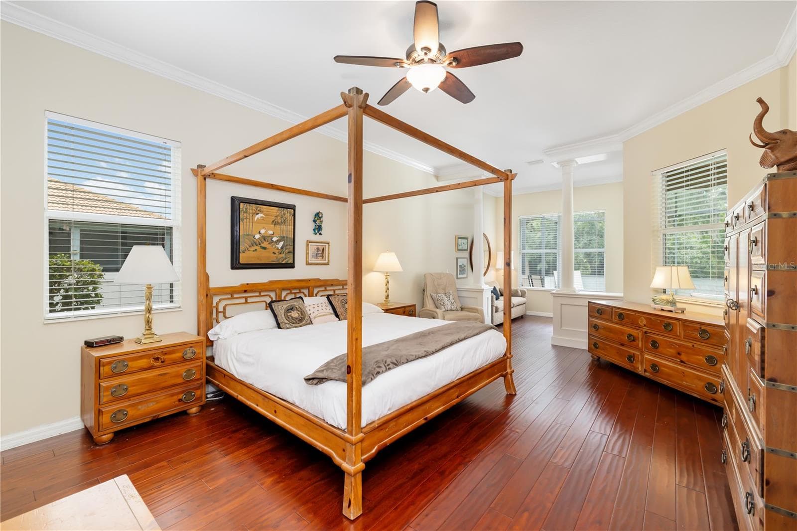 Primary owner suite, with separate sitting area, slider glass doors private entry from the lanai, engineered wood flooring, surrounded by multiple windows bringing in natural Florida sunlight - 12471 NATUREVIEW CIR, BRADENTON