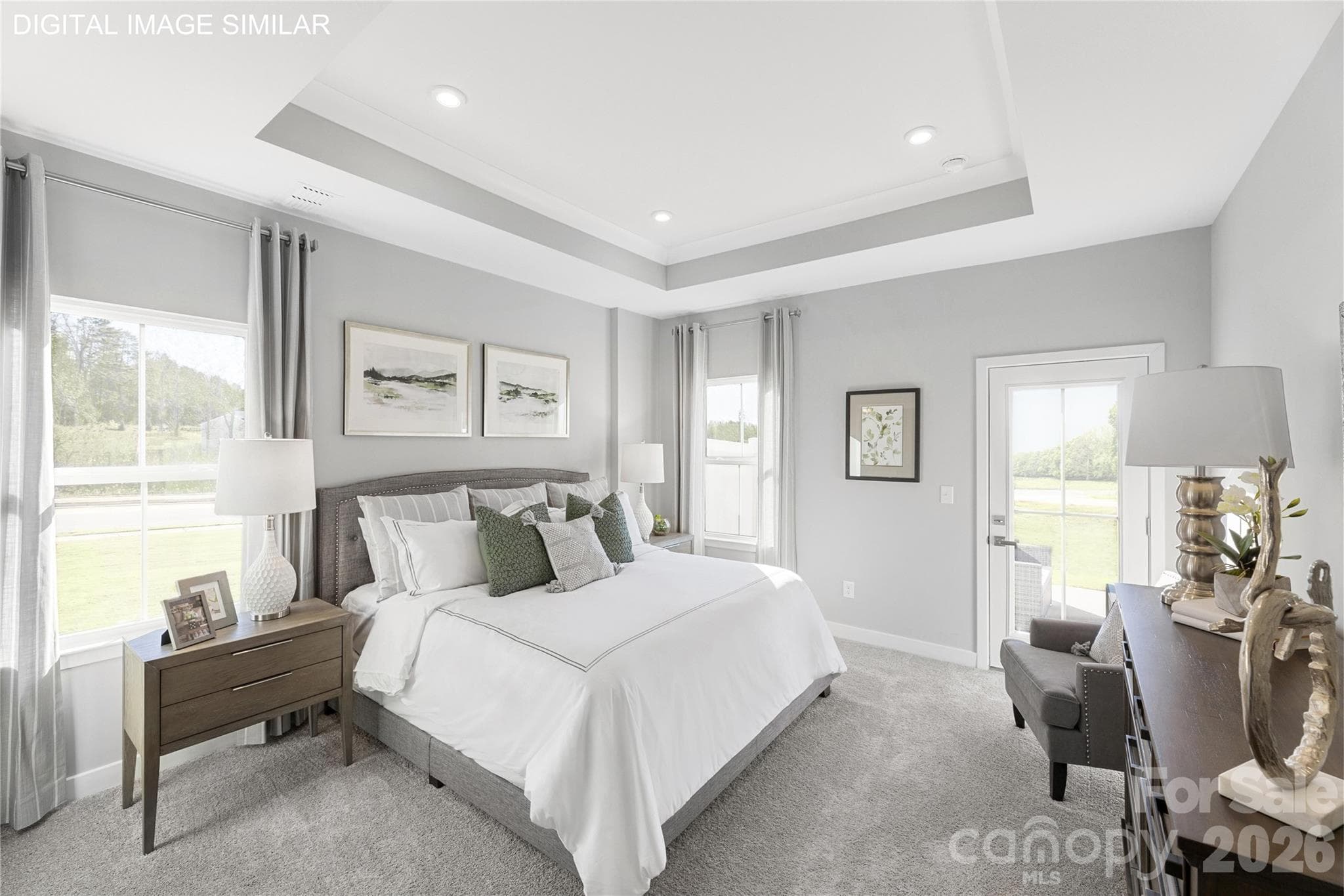 Spacious first-floor primary suite with tray ceiling and abundant natural light—your own private retreat. - 2259 Island Lake Drive, Charlotte
