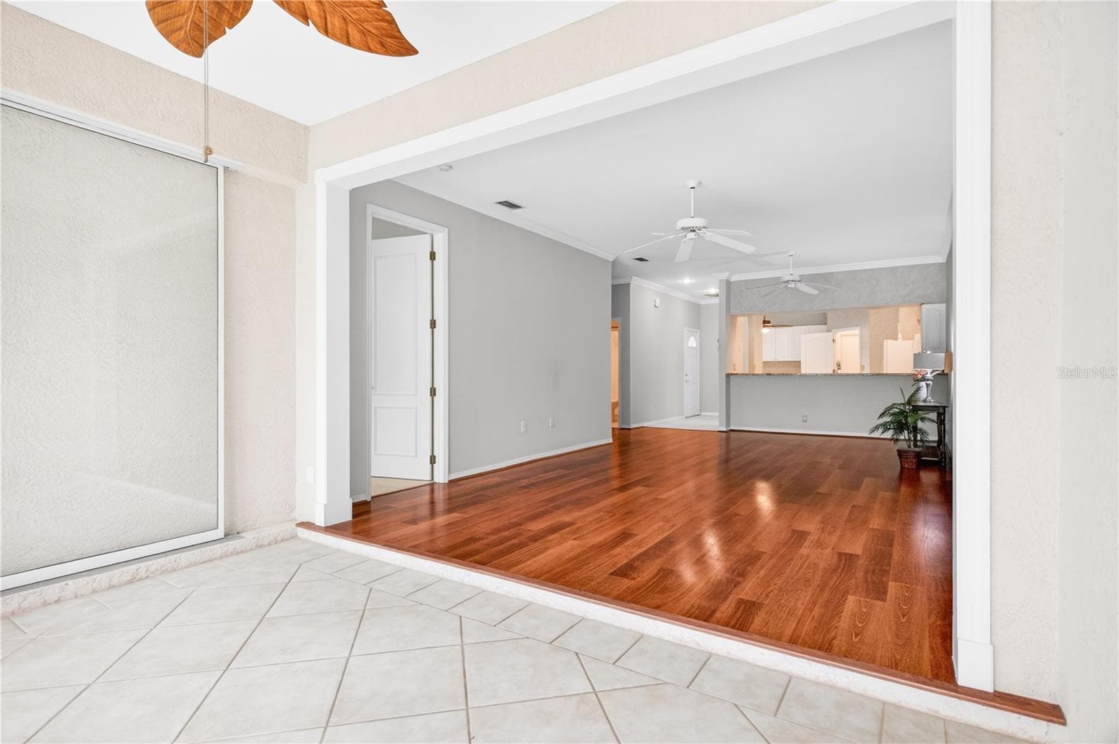 View into living/dining rooms from sliders in lanai - 6948 STONEYWALK CT, BRADENTON