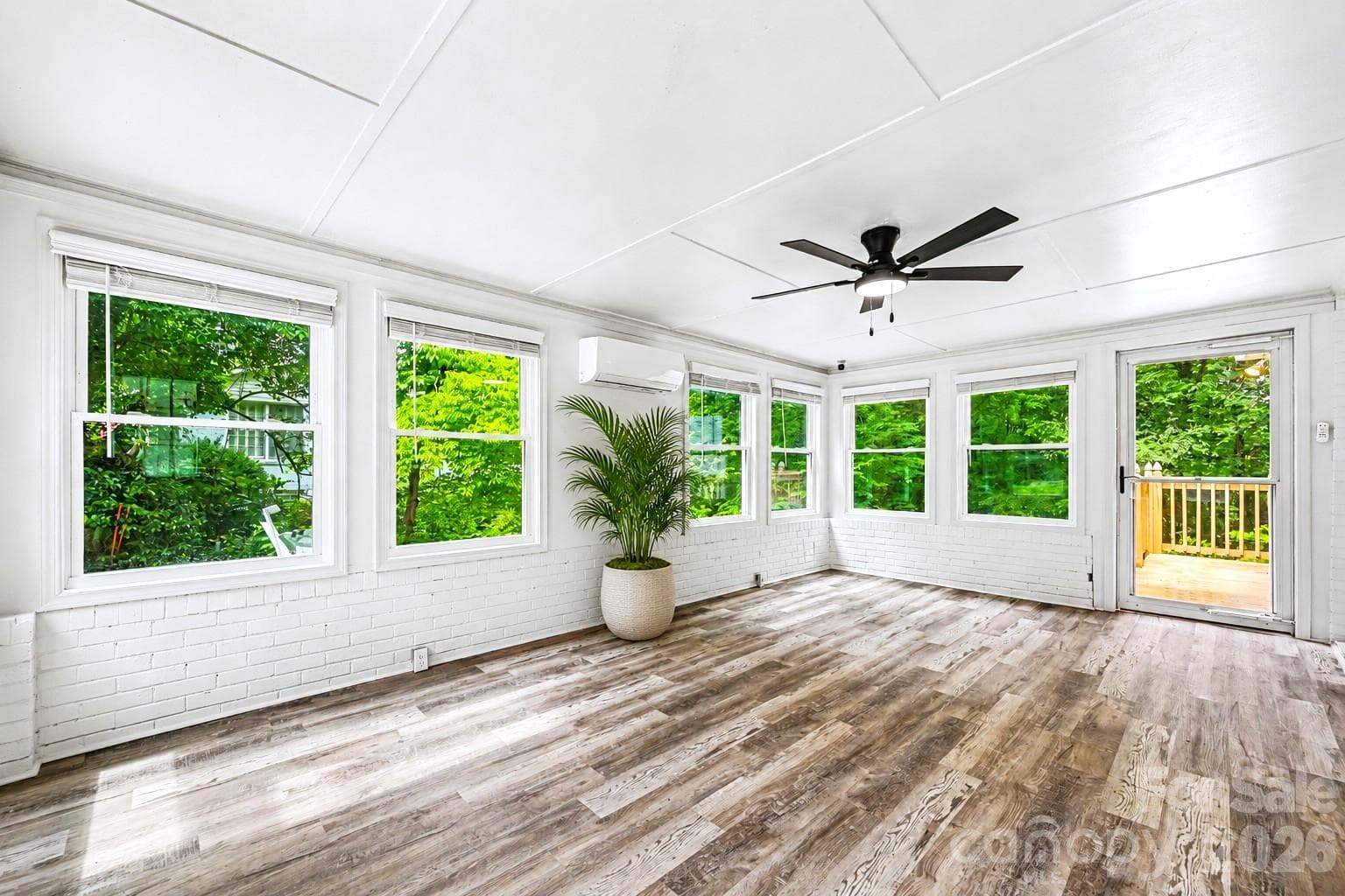 Light filled sunroom with its own mini split system, offering a comfortable space to relax, work, or entertain year round. - Concord