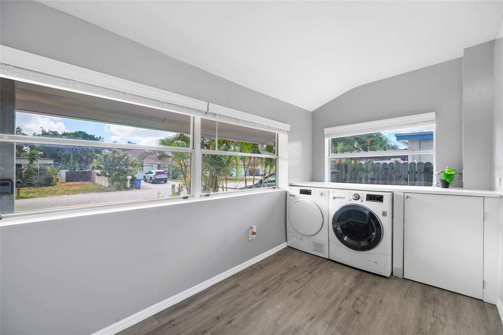 Front door opens into Foyer / mudroom with W/D, large shelf, and has a pocket door to keep noise down. - 5044 BETTY ST N, ST PETERSBURG