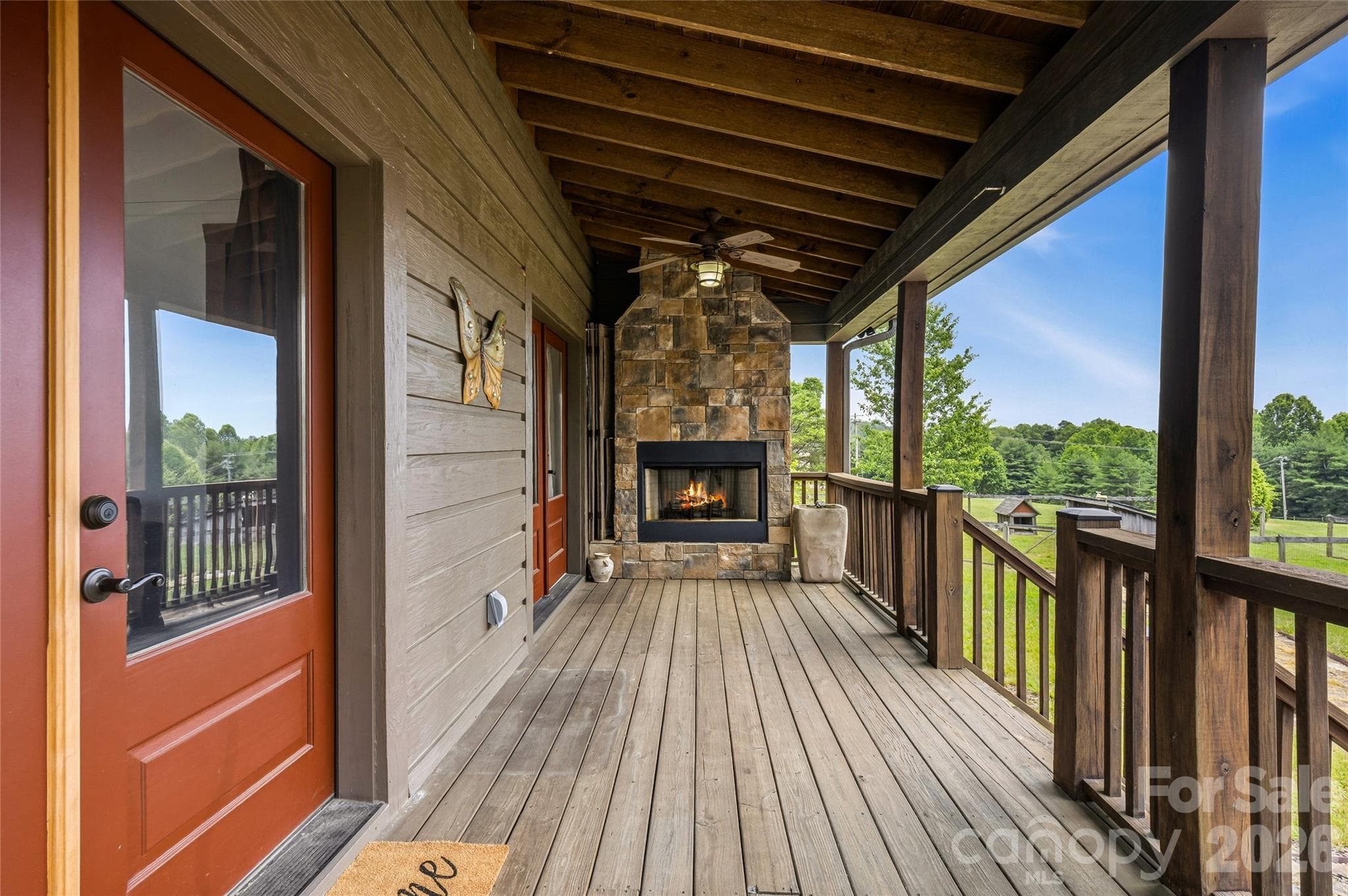 Outdoor stone fireplace on covered porch - 4862 Pinnacle Mountain Road, Zirconia