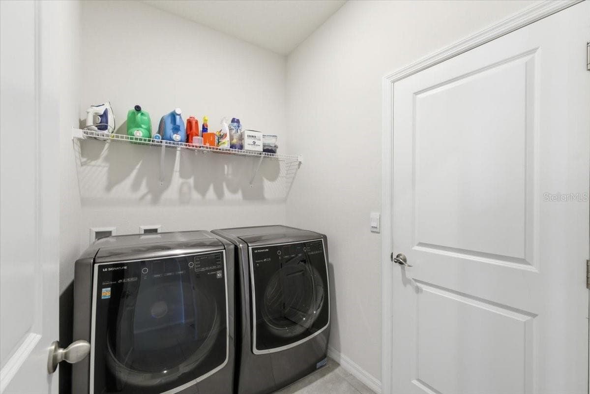 Laundry room leading to the garage. - 1413 TROPICAL OASIS AVE, PLANT CITY