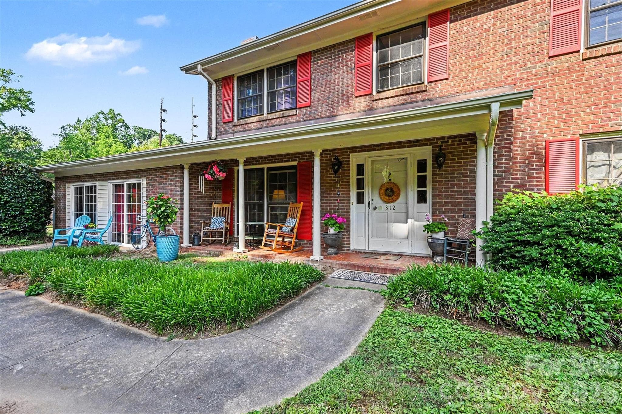 A spacious covered front porch greets you. - Shelby