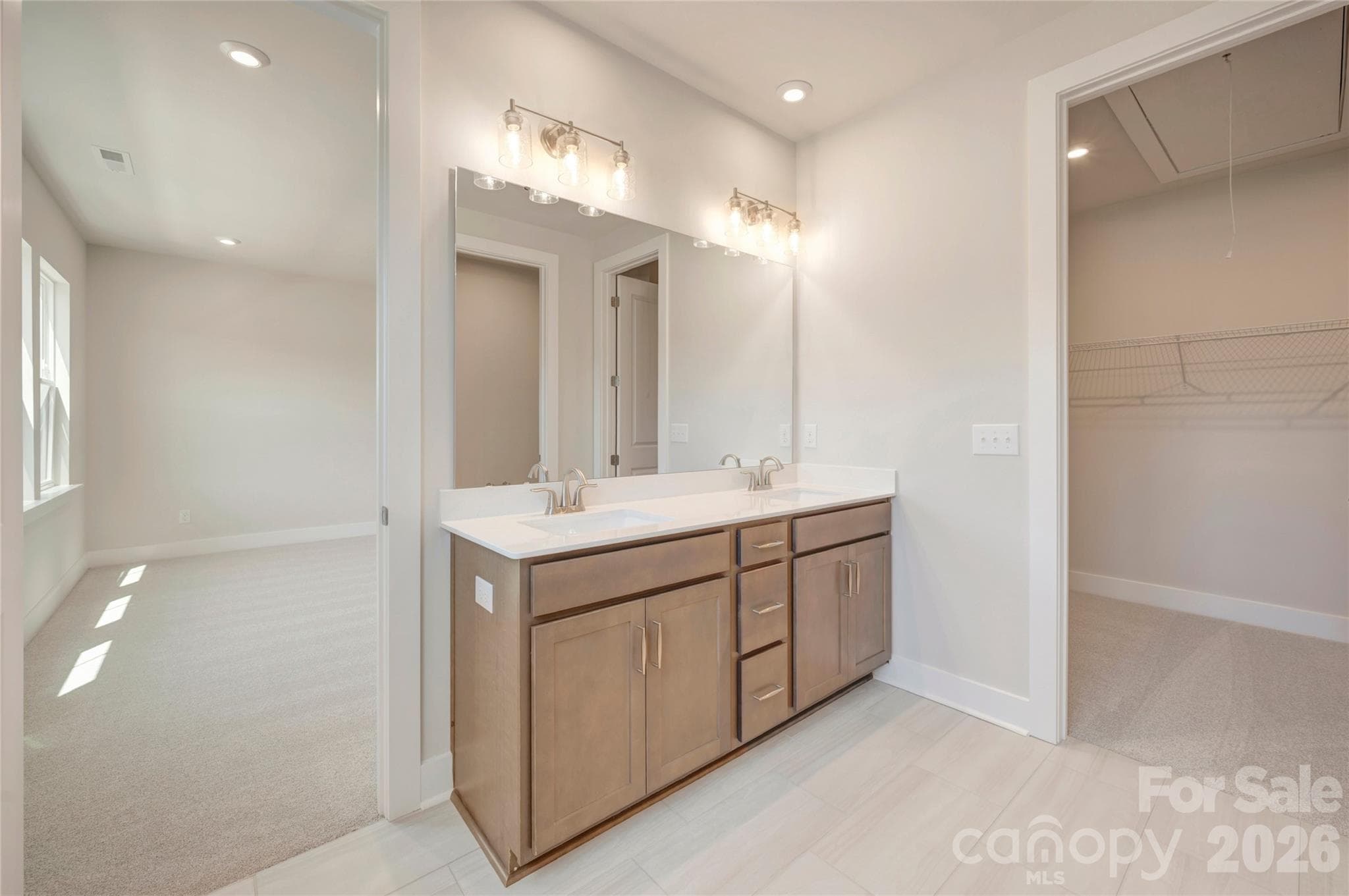 Dual vanity primary bathroom with access to the walk-in closet - 316 Ardmore Drive, Belmont