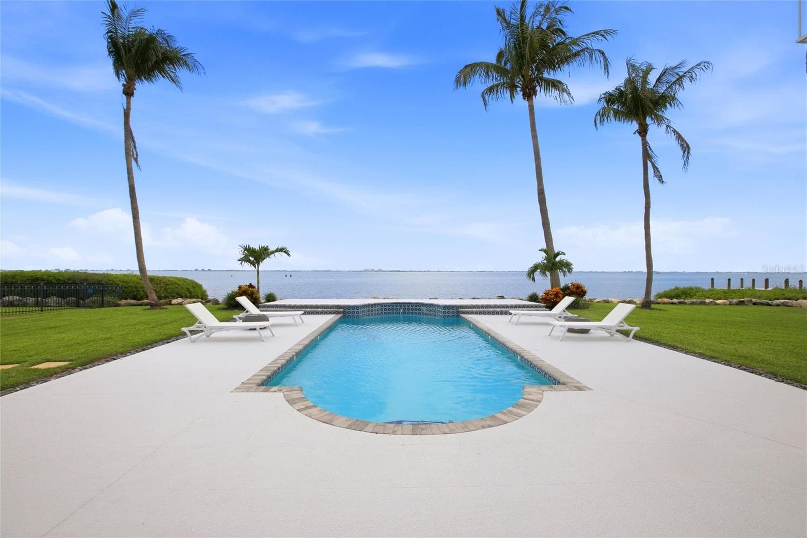 A view from the deck to the pool to the Sarasota Bay to Longboat Key and beyond. - 7524 WESTMORELAND DR, SARASOTA