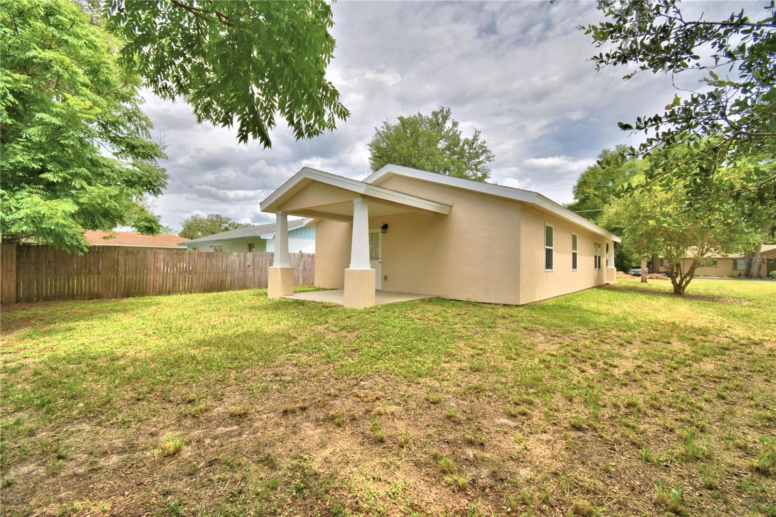 Right corner of backyard looking to the house - 2456 BATES AVE SW, WINTER HAVEN